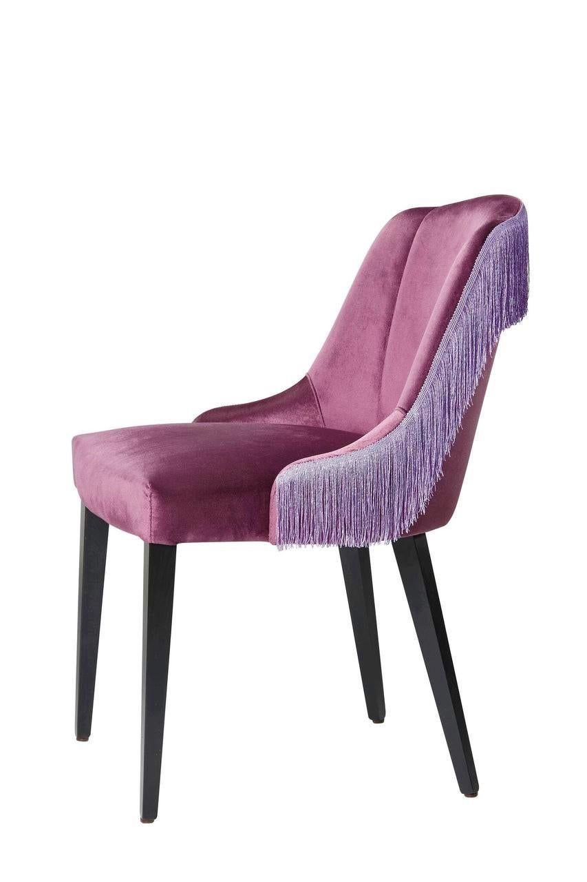 Designed and manufactured in Italy, this set of 6 fully upholstered dining chairs feature fun fringe detail on each back. 

These chairs are manufactured with special attention to the contract market including upholstery with high density, fire