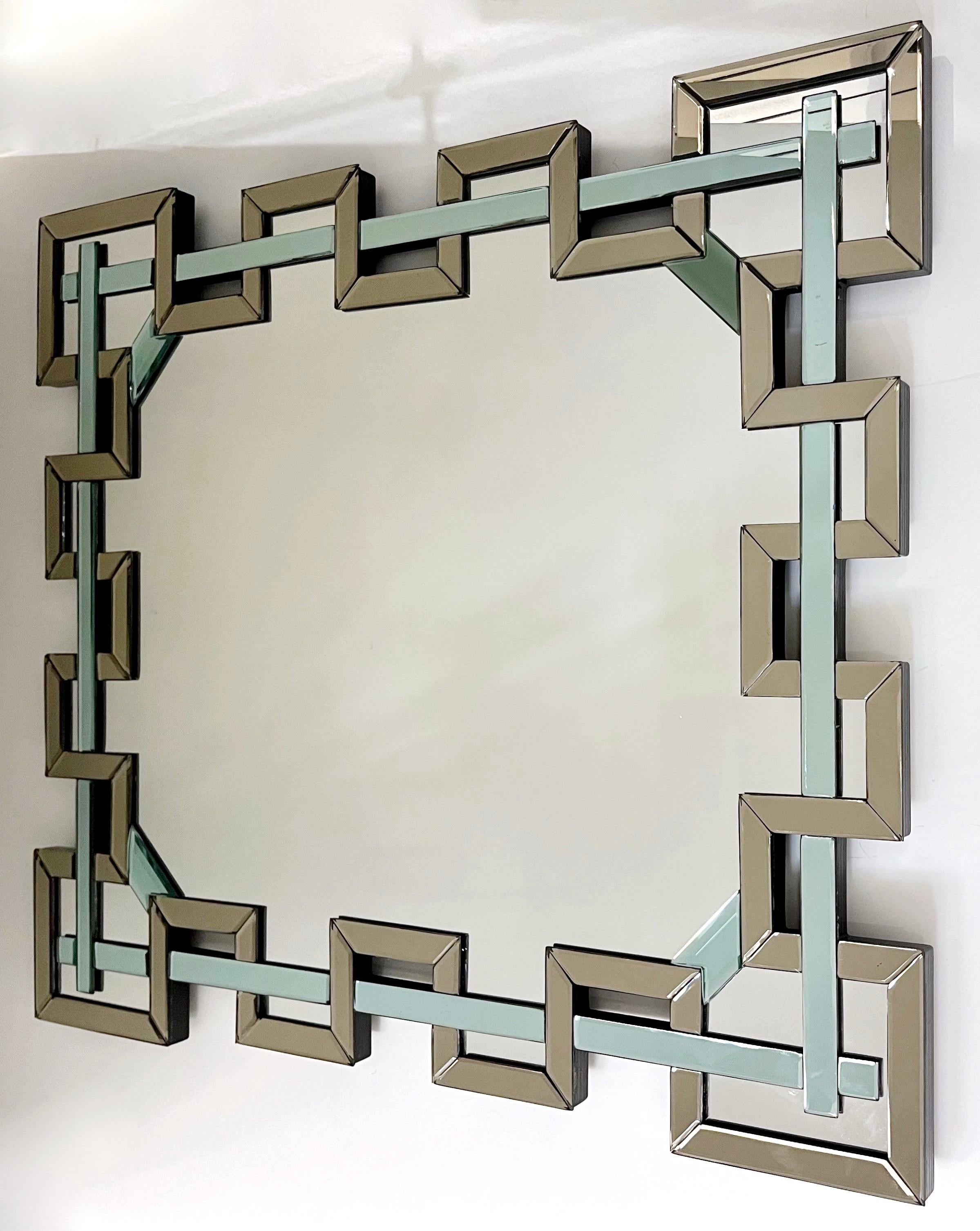 An exclusive Venetian rectangular mirror in Murano glass, entirely handcrafted in Italy with a unique modern architectural design of a crenelated decoration. High quality of execution: the border is finished with an antiqued beveled mirror edge in