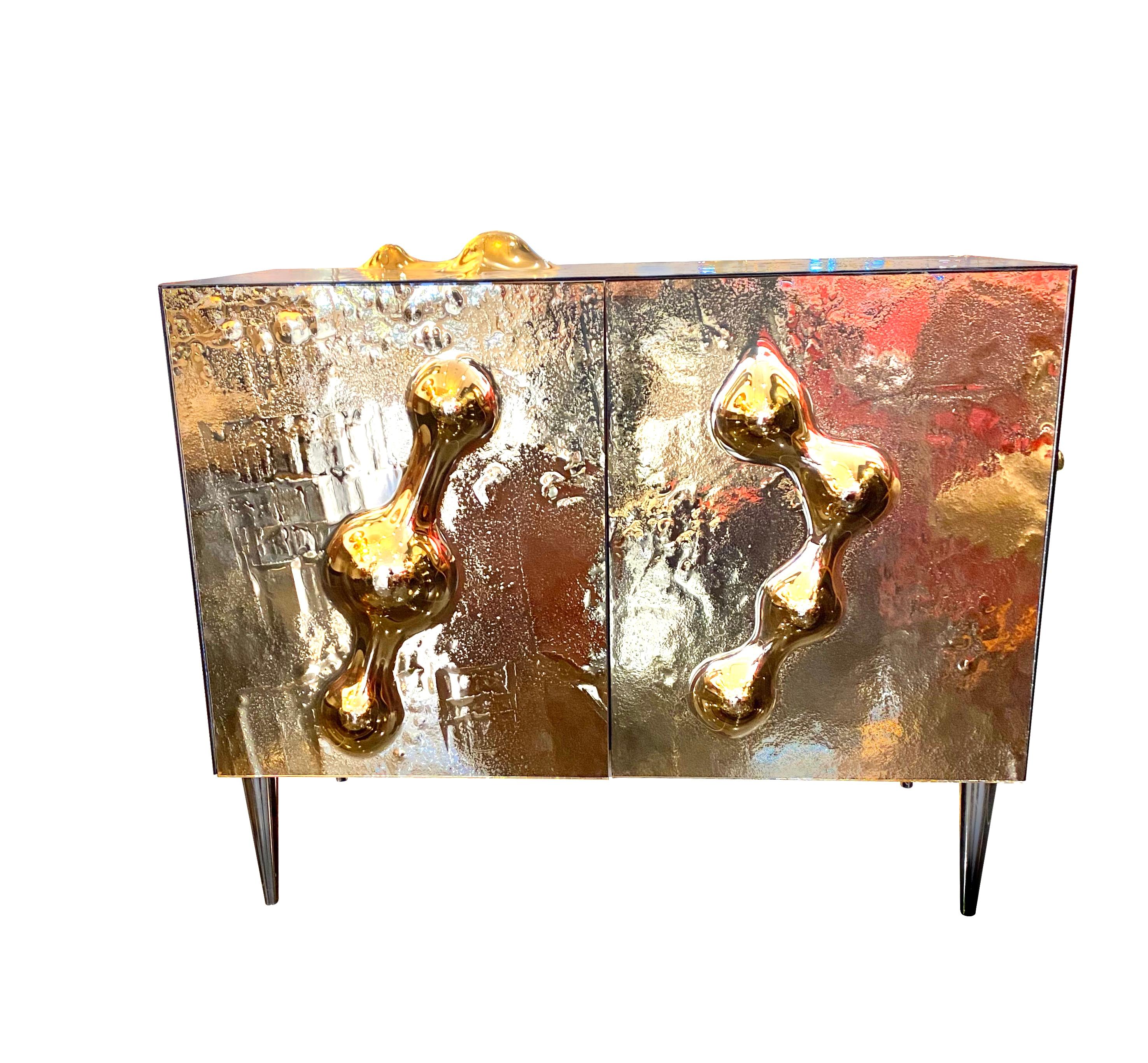 An extraordinary all glass art cabinet designed uniquely for Studio RKade by Atelier Vetro Effetto.Milan

The cabinet is completely handcrafted with a copper mirrored exterior depicting a Martian landscape with intricate detailing.

The cabinet