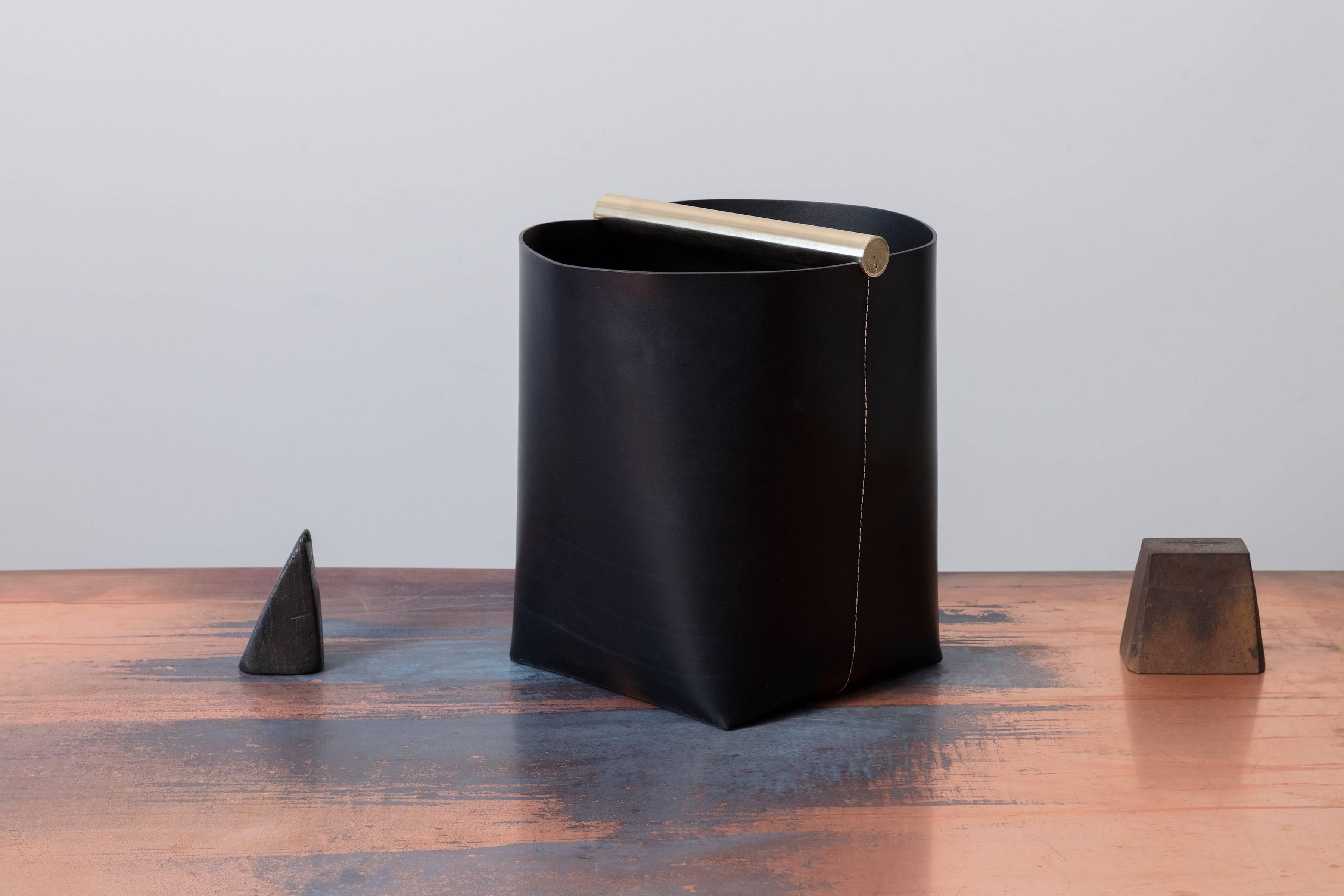 Part of Les Few's Julie collection, this contemporary, leather and brass, modern, minimalist waste paper basket are made by artisans in Sweden. The leather waste paper basket comes in jet black with jet black leather interior, white contrast