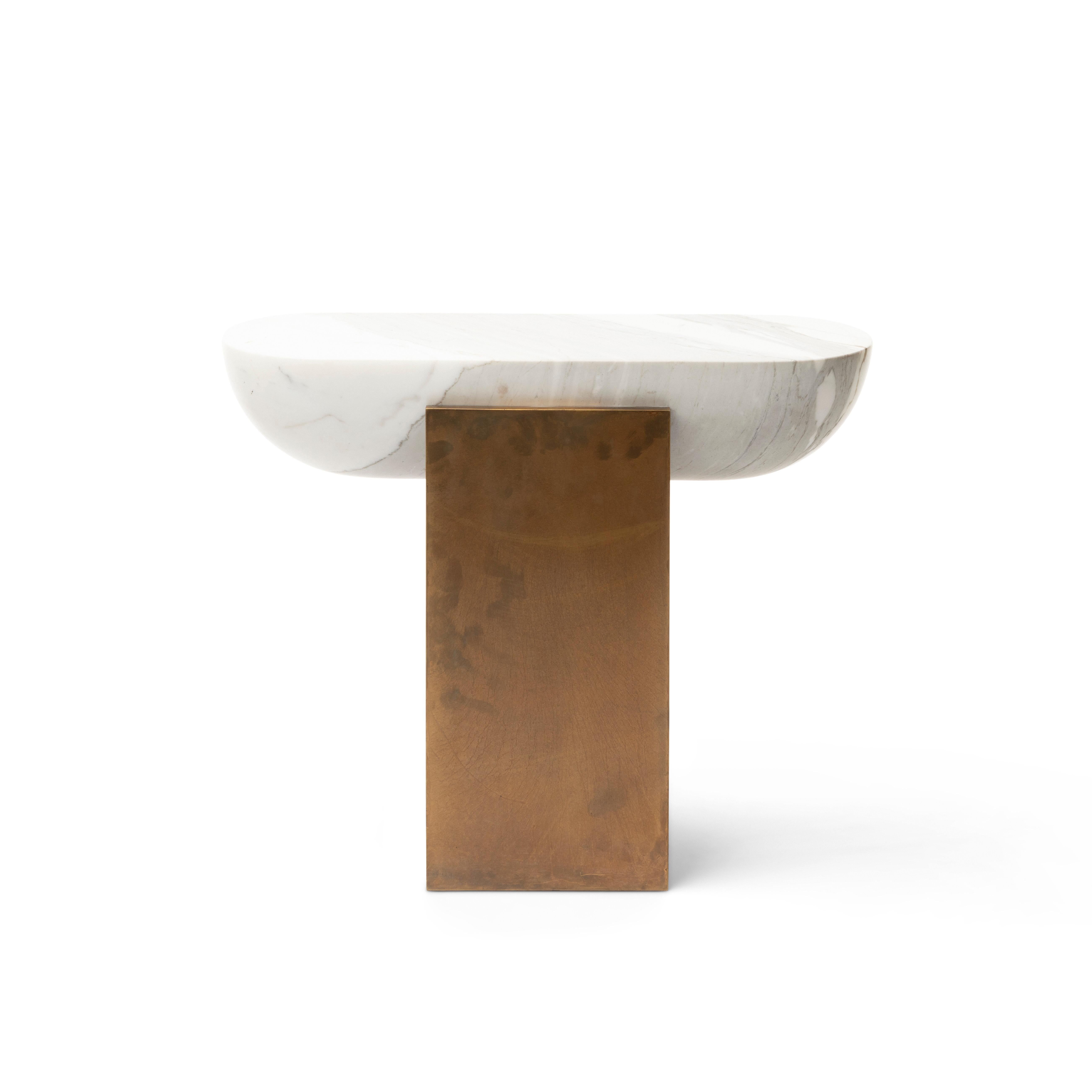 Honed Italian Calacatta marble cupped by a patinated brass plinth; the PILL’S charm is in the justice of its proportions, and the vibrations of its materials. Intentionally slender, the PILL's silhouette allows it to make a statement in the