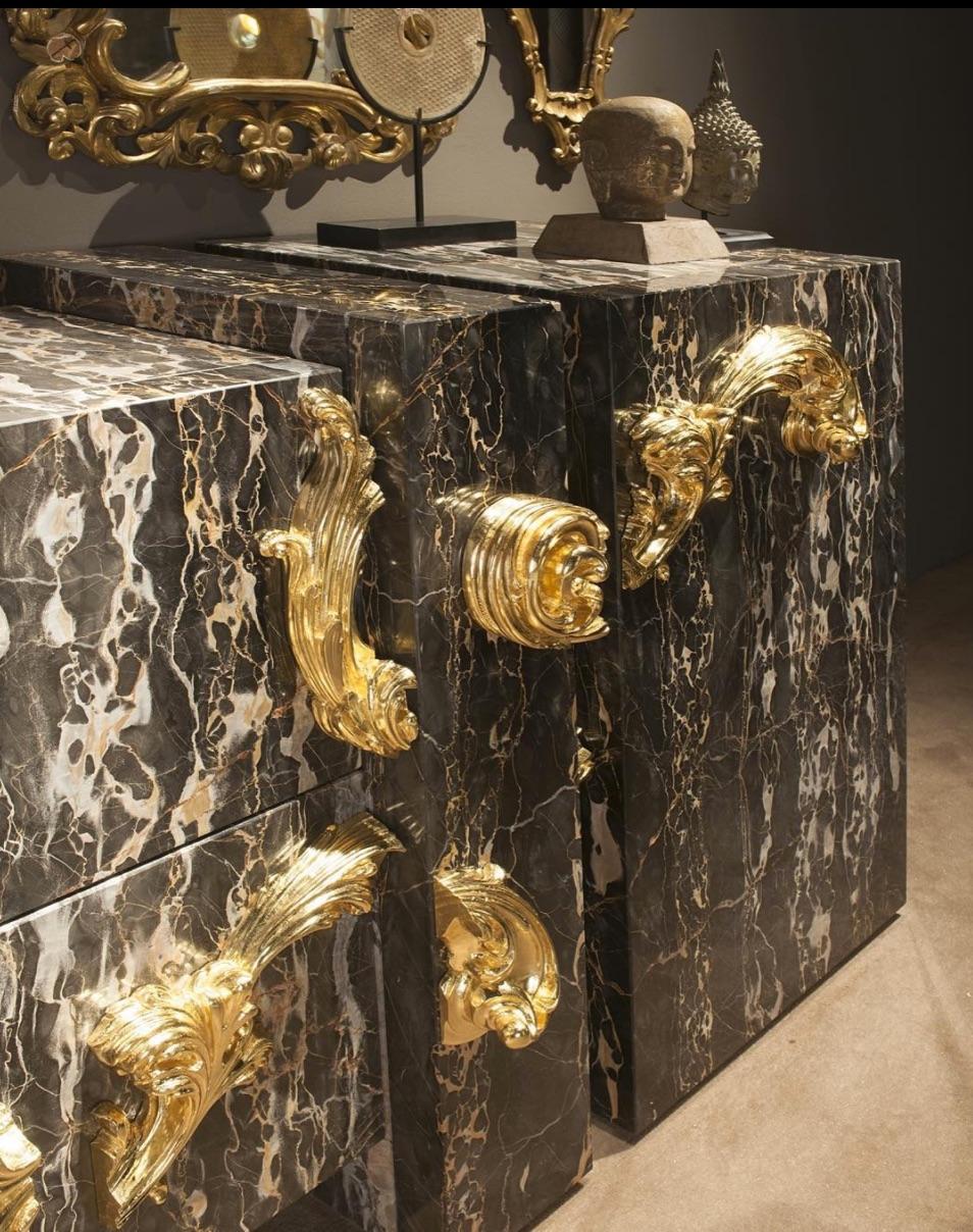 An example of modern Italian style is evident in this marble cabinet designed with Nero Portoro marble and finished with hand carved wood details & gold leaf finishes. A laconic image created with exquisite details and materials combined with