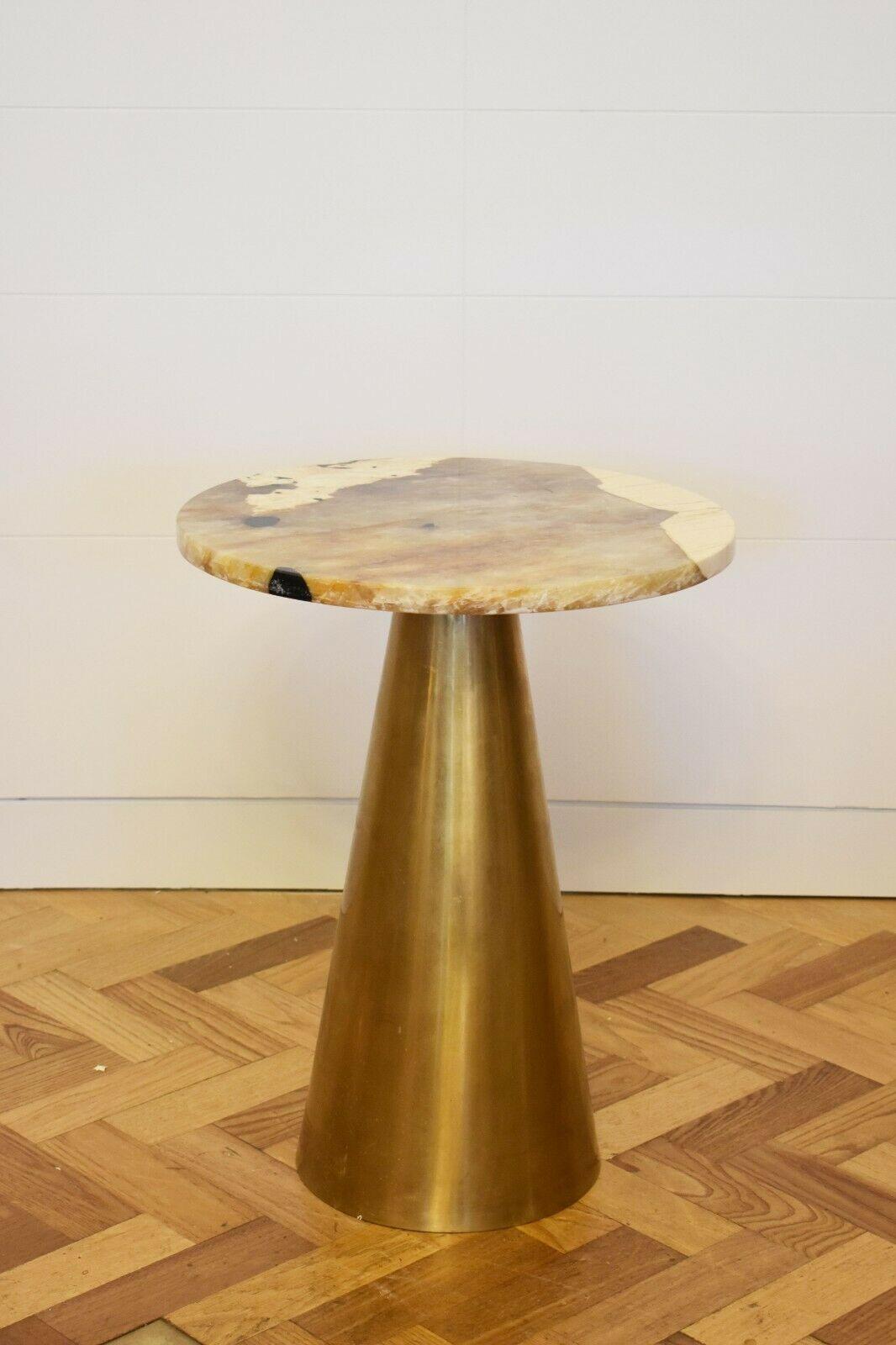 Contemporary Italian marble side table with a brass base.

This side table features an intricate and beautiful round natural marble top, set upon a cone brass base. 

Useful, elegant and stylist, this side table is perfect for any sleek