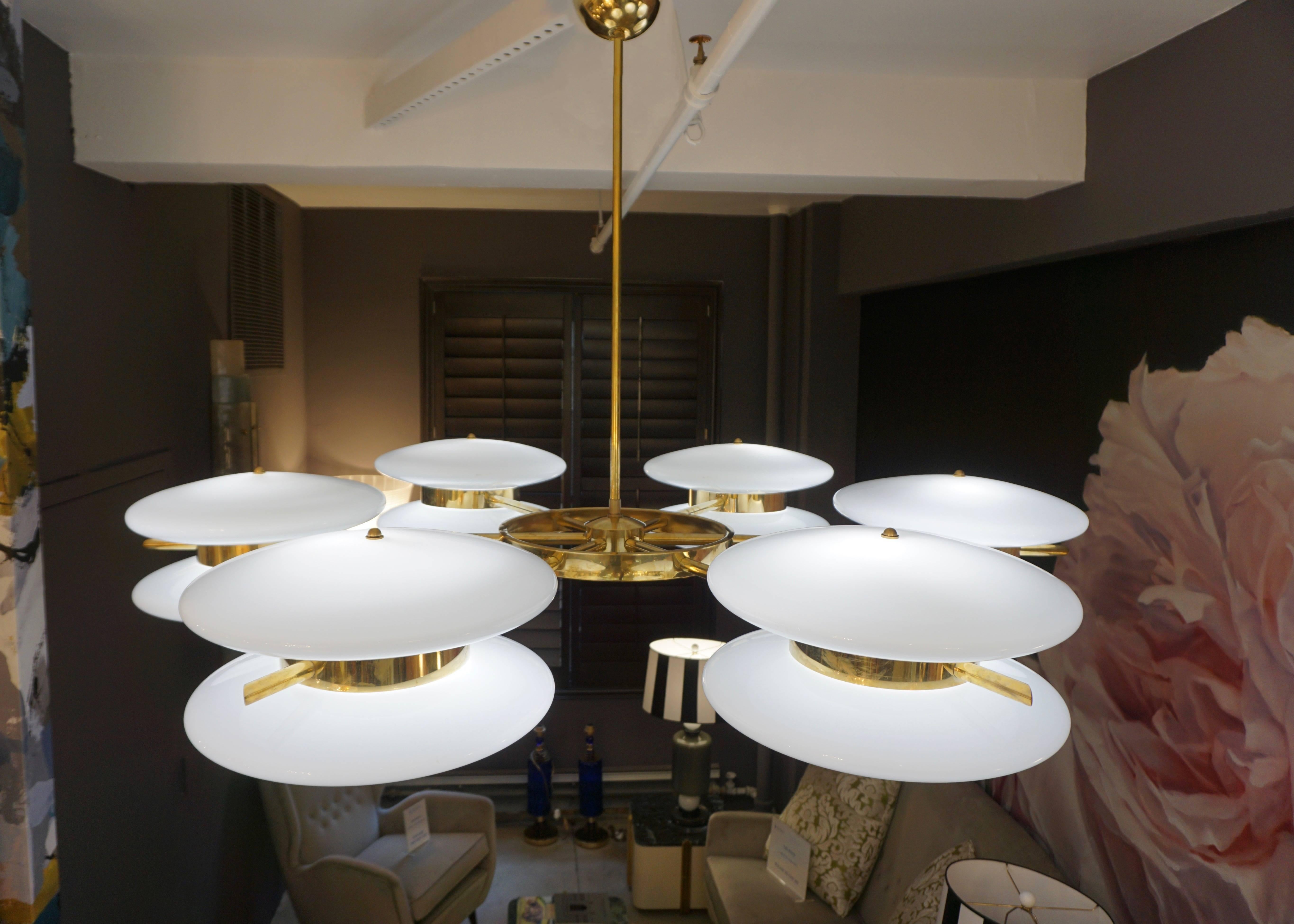 Italian fine organic wheel chandelier, entirely handcrafted in Italy with Exclusive Design, the airy modern round structure in brass with a central wheel element supports six surrounding white Murano glass double globes (15 in. Diameter) inset in a