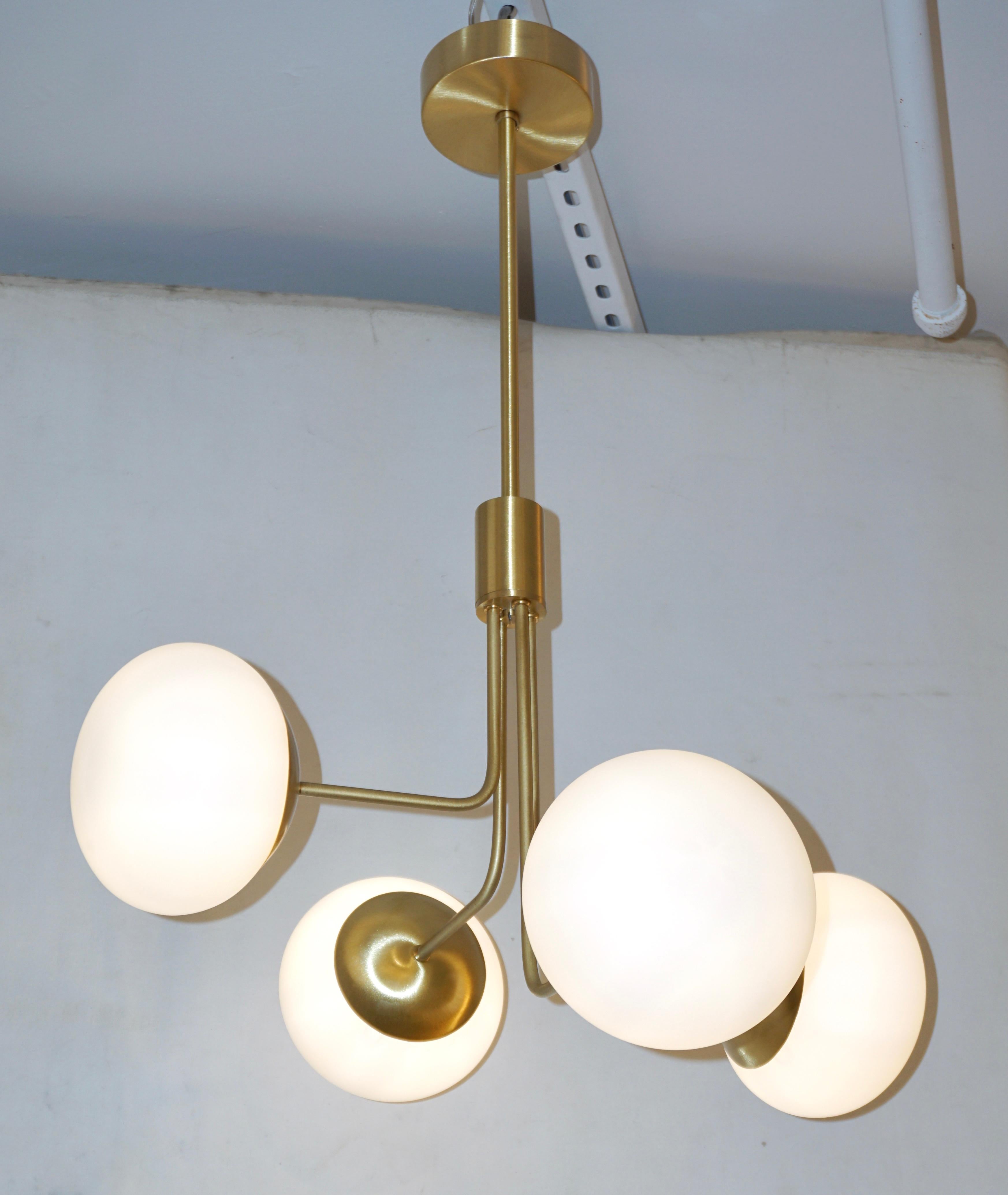 A minimalist Italian structural lighting fixture in Mid-Century Modern design, entirely handcrafted recalling Gino Sarfatti style. The asymmetrically positioned four ovoid globes in white opaline Murano glass give an interesting movement to the