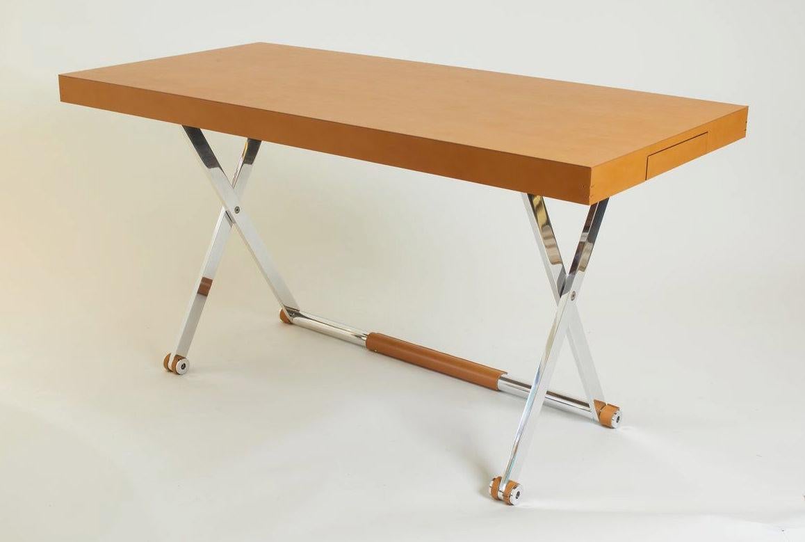 Contemporary Italian saddle brown leather luxury folding desk with matching foldable leather and metal stool. The top of the desk is made in solid wood covered in leather, with legs in polished aluminum.