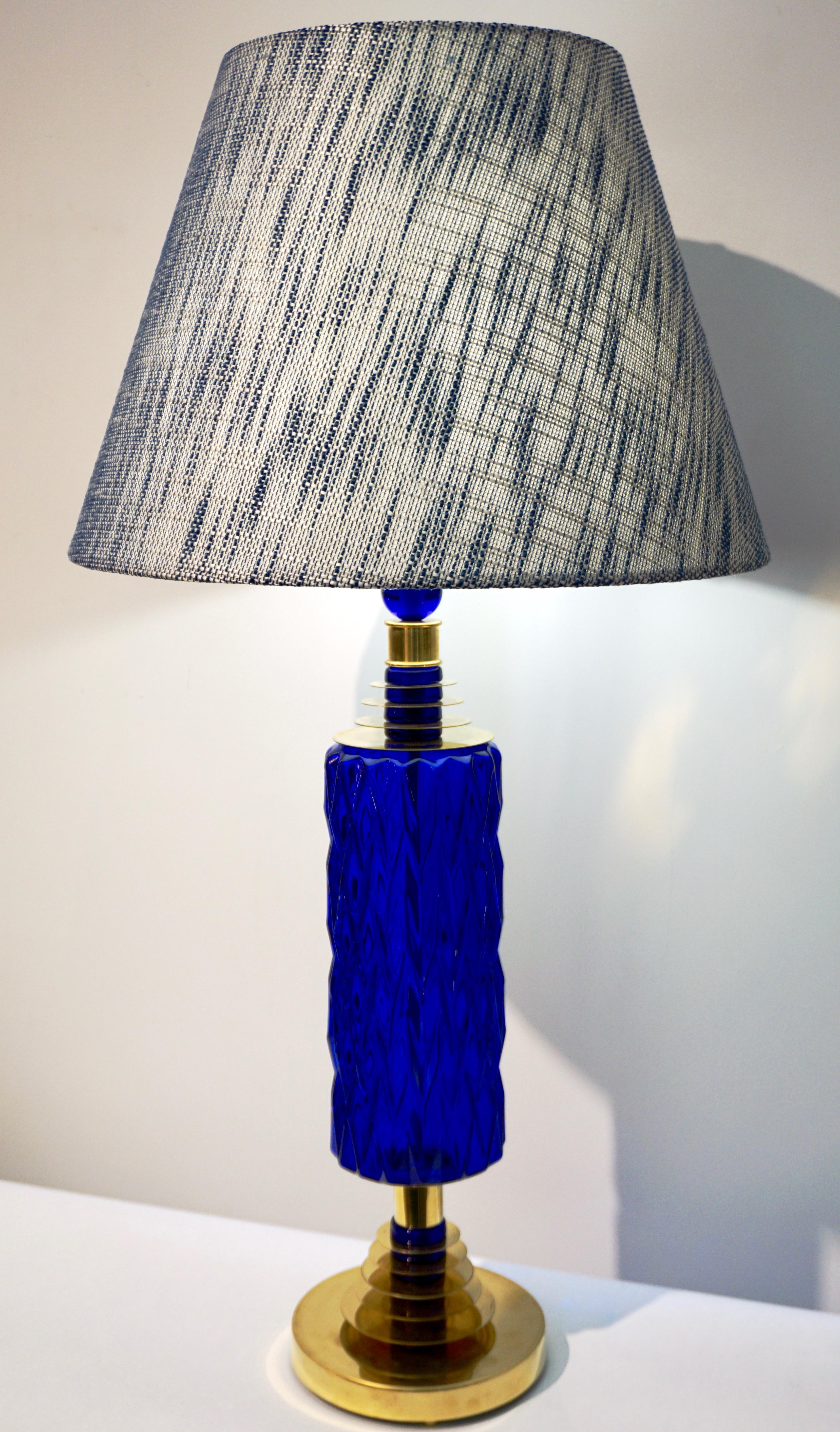 A tall modern pair of blown beehive Murano glass lamps, high quality of craftsmanship, organic design with blown royal blue bodies, preciously decorated with a diamond cut pattern and supported by hand made brass stepped accents interspersed with