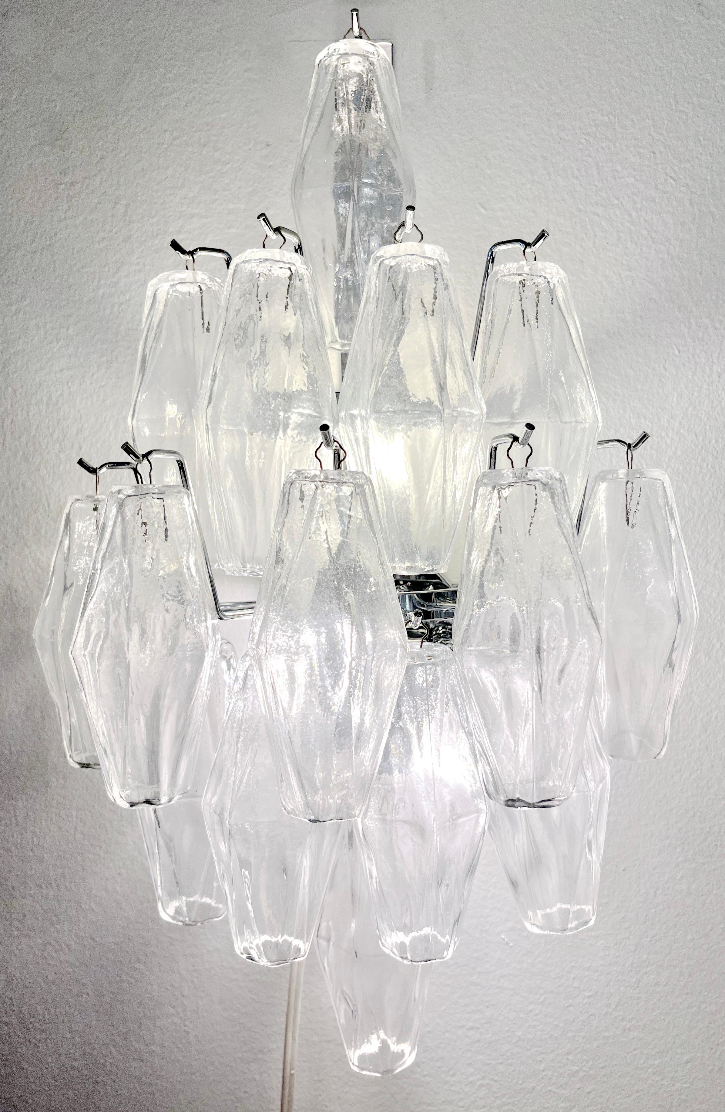Modern Italian organic airy design cascading sconces, entirely handcrafted, in Art Deco style. The blown polyhedral elements in crystal clear Murano glass are layered in multi-levels on a handmade nickel structure. The light is diffused through the