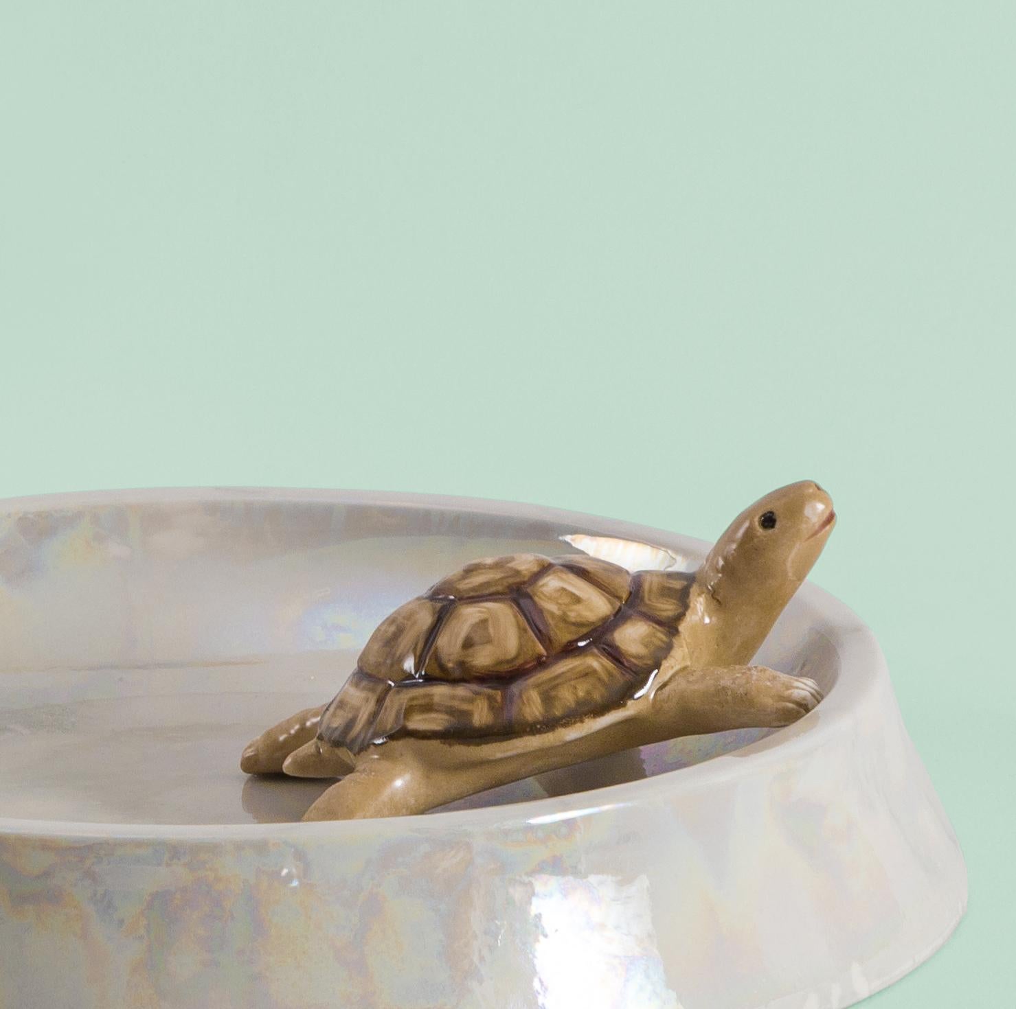 This Italian porcelain sculpture is part of Grand Tour by Vito Nesta. Made in Capodimonte porcelain with a glossy and iridescent finish. This pocket emptier is embellished by a hand painted turtle.
