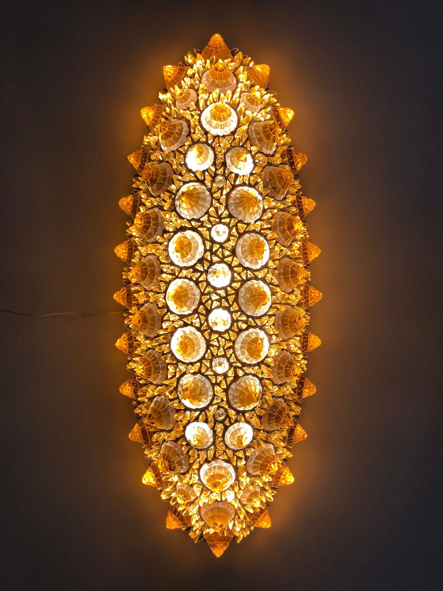 Bring the sun indoors! A jewel-like Italian oval pendant or flush mount chandelier, Work of Art sculpture, entirely handcrafted, the sophisticated organic decoration is composed of hand-cut rock glass diamond elements of different sizes set in a
