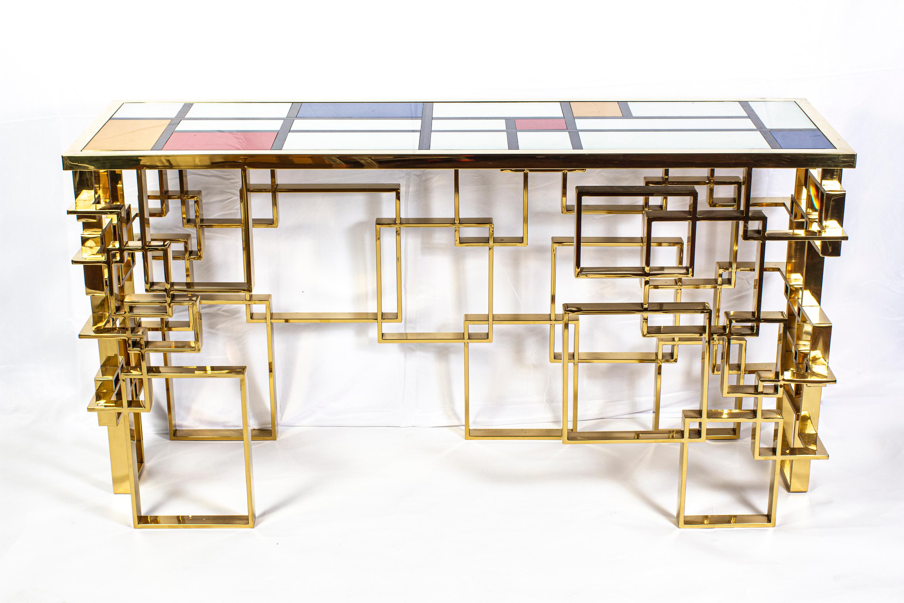 Fabulous modern brass sculpture console table or center table with a Mondrian motive glass top. 
Handmade by a master artisan.
The glass top color we can customize on request.
Available also a pair.