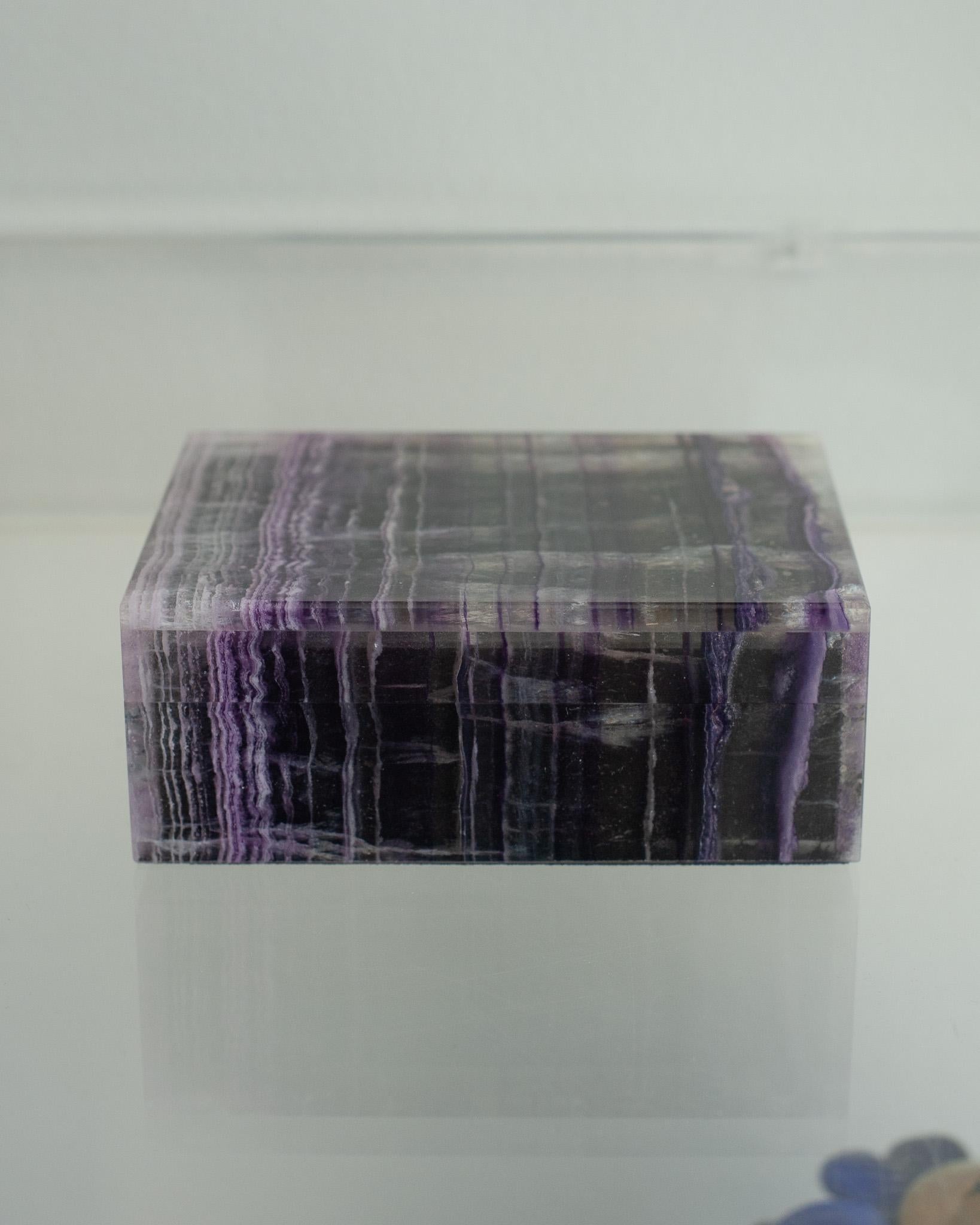 Invitez l'énergie de guérison dans votre maison avec cette exquise petite boîte en fluorine violette. Les teintes douces mais vibrantes de la fluorine pourpre sont magnifiquement mises en valeur, créant une présence apaisante qui favorise la paix et