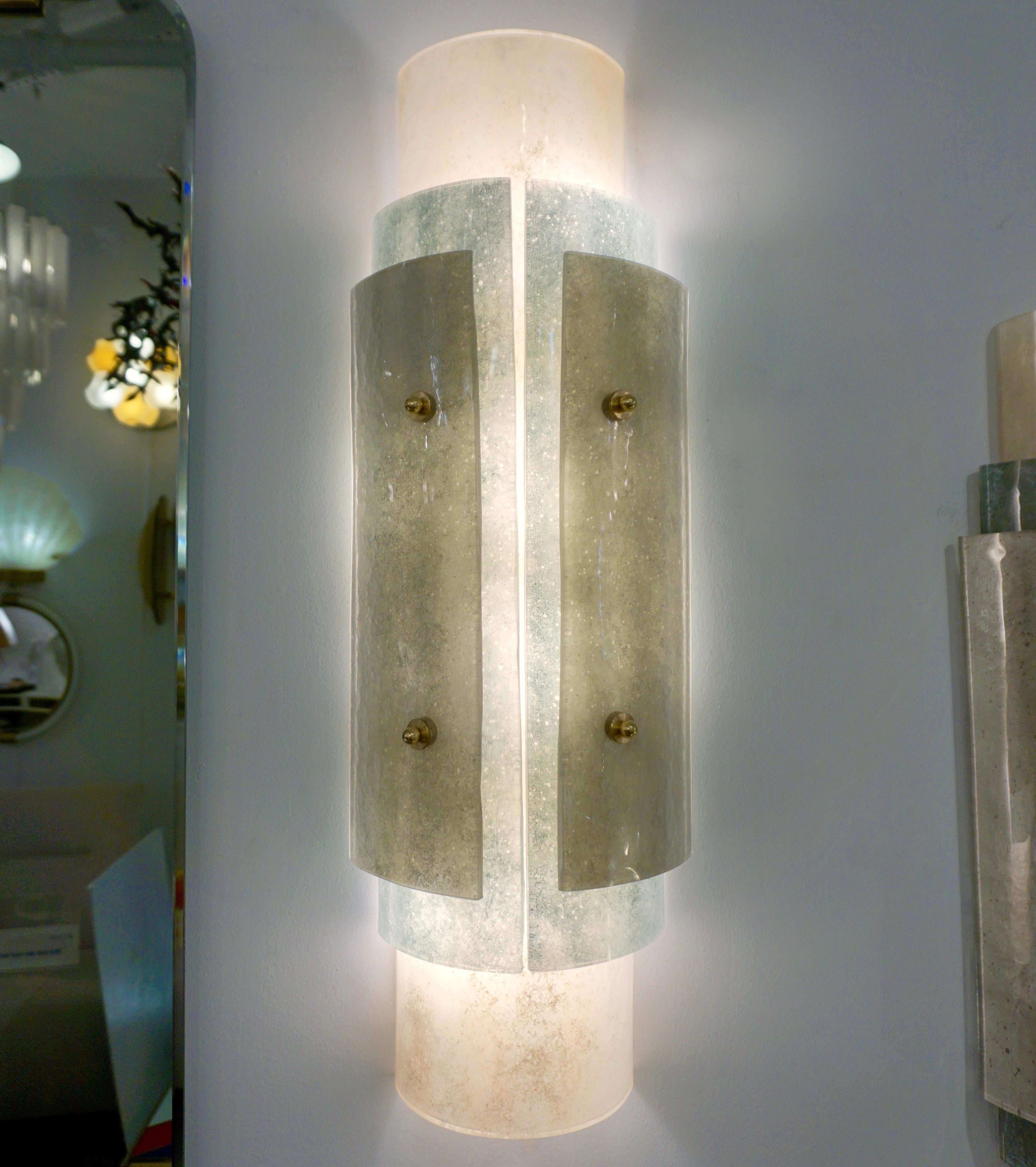 A very elegant and refined Italian Mediterranean design in blown Murano glass worked with the technique scavo: the frosted glass has a finish similar to archaeological ancient Roman glass findings and recalls Venetian plaster texture. Three varied