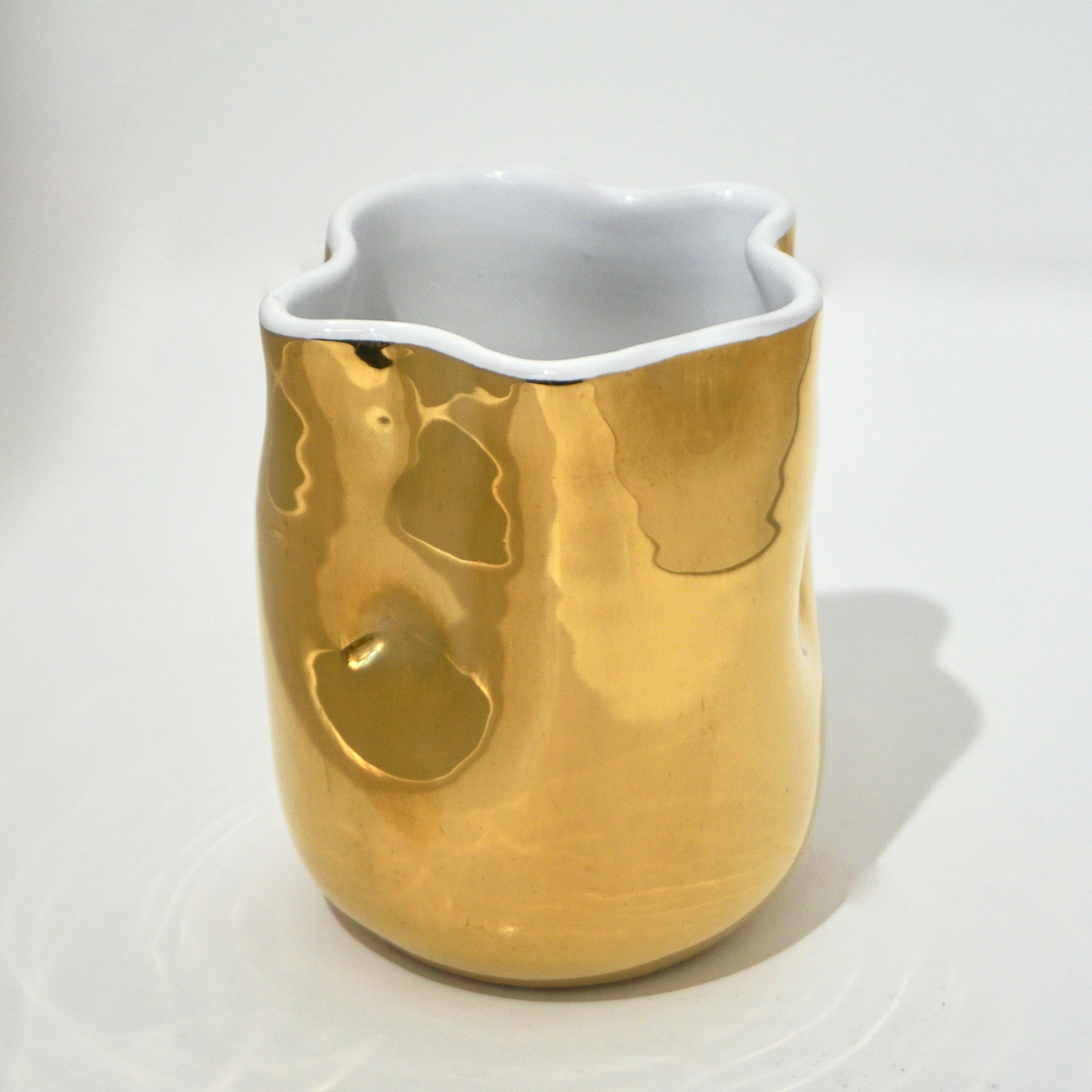 Contemporary modern tumblers/glasses of organic waved design, entirely handcrafted in high quality white ceramic for the interior and externally decorated with pure gold. It is food safe and can be used as tableware or as a decorative small vase,