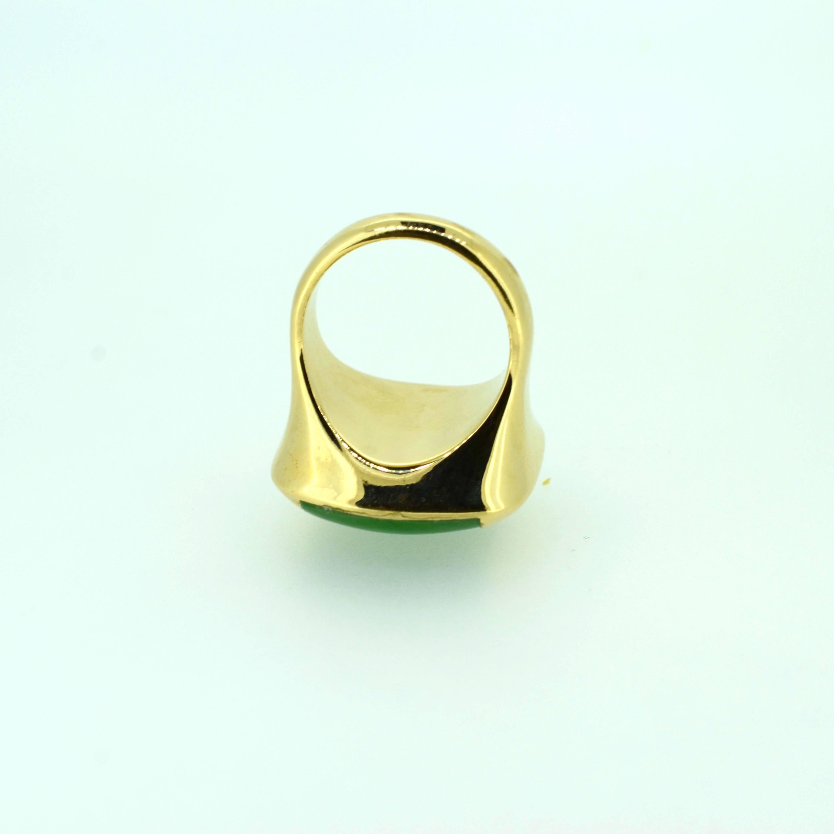 Jadeite 18kt yellow gold ring: Contemporary design, wax carved and cast in solid 18kt yellow gold base and shank. Jadeite is softly domed23X16mm soft rectangular shape and bezel set on the sides. Ring weighs 14.3 DWT.