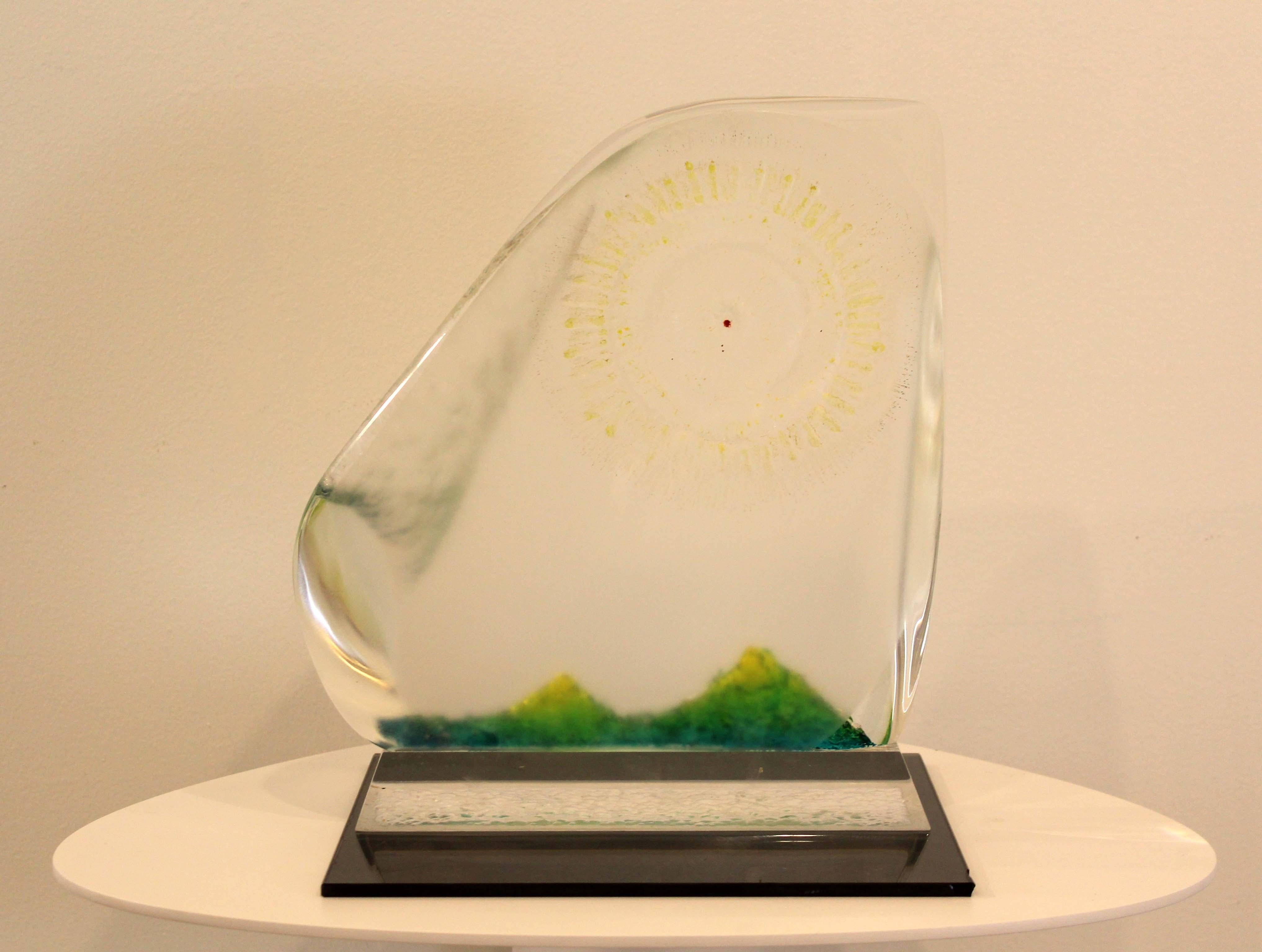 A fantastic acrylic sculpture with inlaid green and sunbeam designs by Detroit sculptor James Nani. A lovely addition to a modern décor. Circa 1980s. Dimensions: 12.75h x 9d x 11w. In excellent vintage condition. 

James Nani (1926-2016) was a