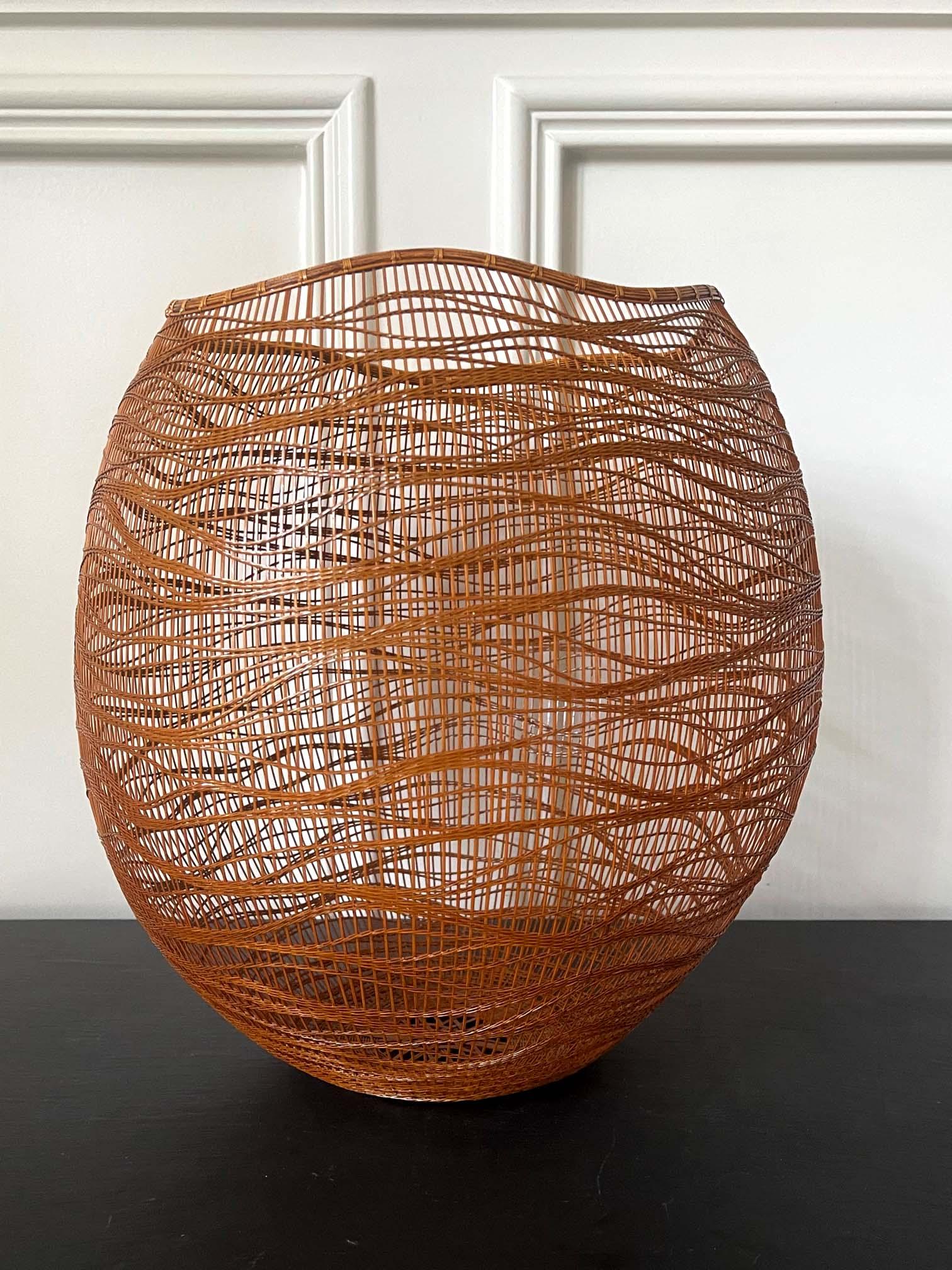 A wonderful woven bamboo basket with a sculptural form hand crafted by Japanese Bamboo Artist Morigami Jin (born 1955-). It was constructed with split Madake bamboo strips and rattan fiber, using free hand twining and wrapping techniques.
