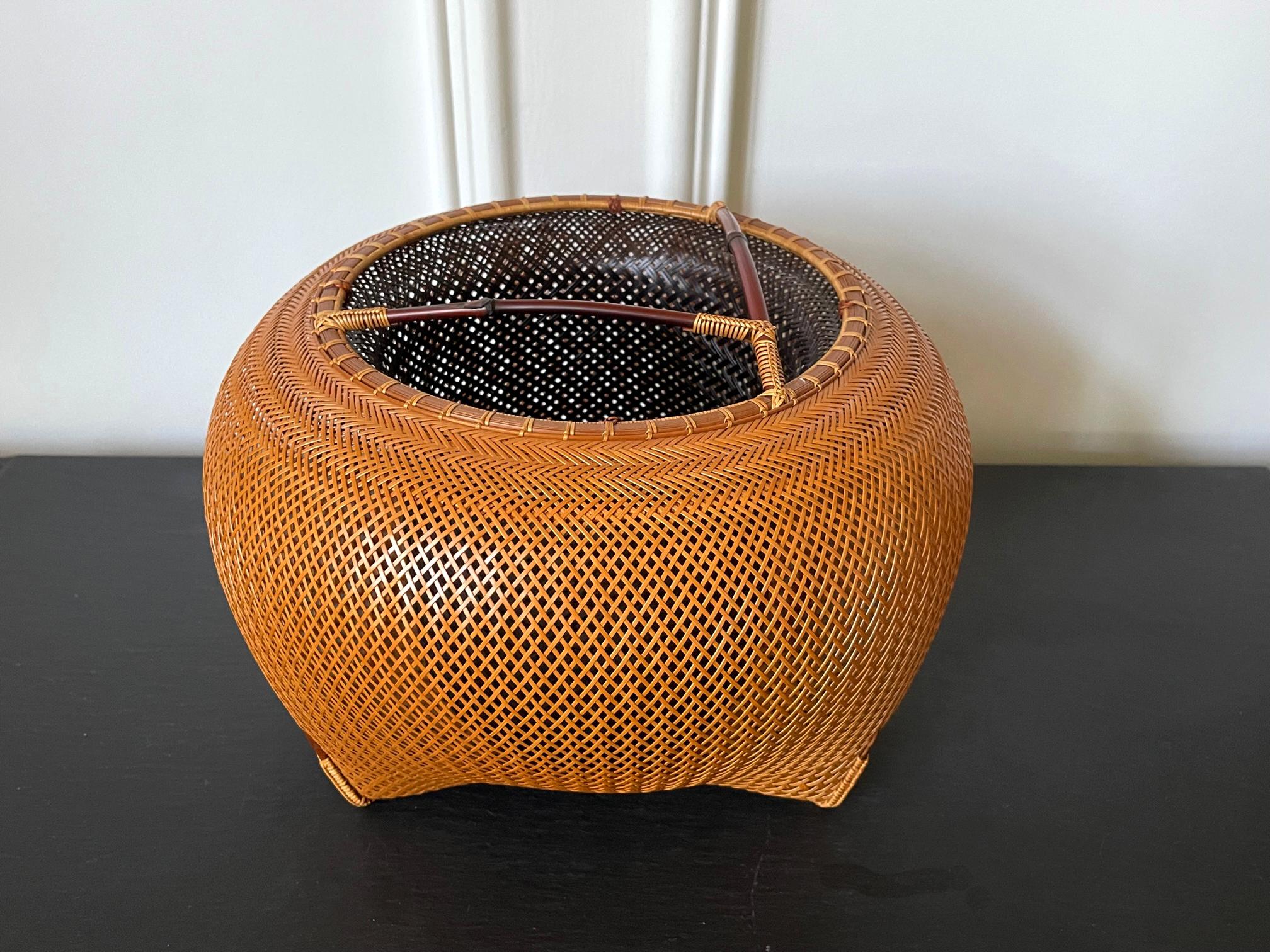 A beautiful bamboo sculpture in a double-walled basket form by contemporary Japanese bamboo artist Kawano Shoko (born 1957-). The piece entitled 
