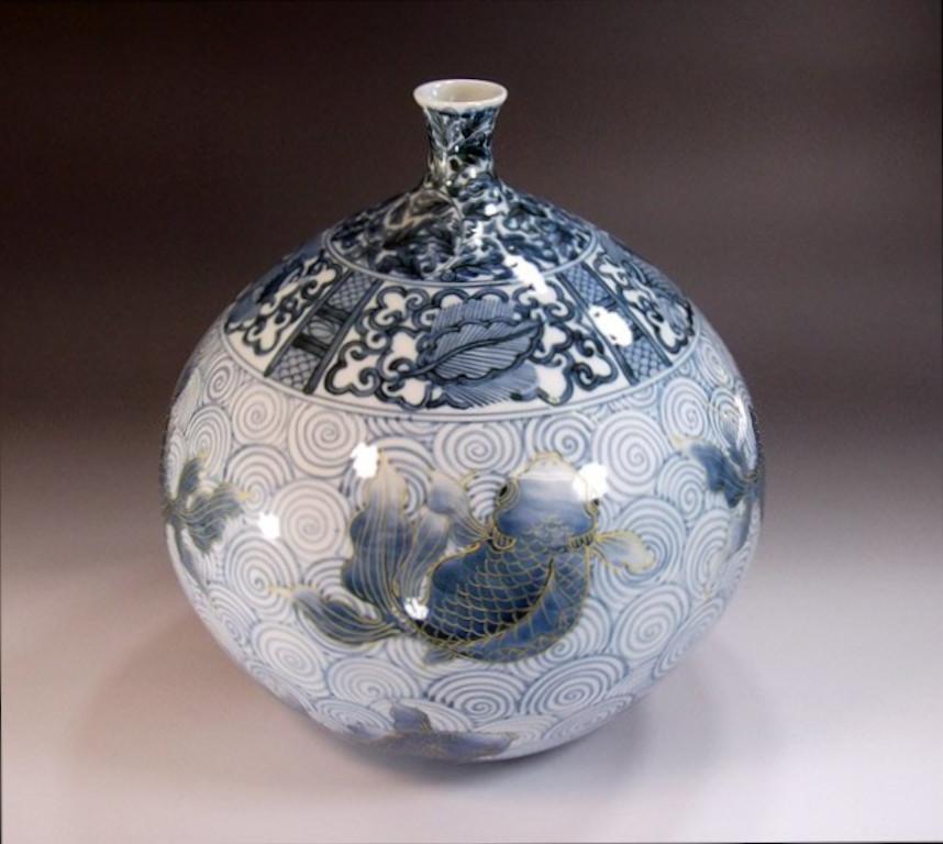 Japanese contemporary porcelain decorative vase, hand painted in blue underglaze in stunning shades of blue and gray on an elegantly shaped ovoid porcelain body, a signed piece by highly acclaimed master porcelain artist in the Imari-Arita