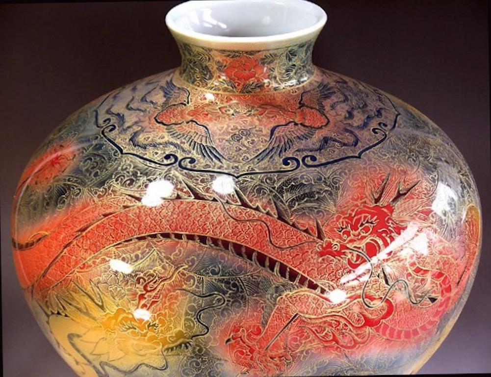 Mesmerizing large contemporary Japanese museum-quality decorative porcelain vase, stunningly hand painted in extremely intricate patterns and extensive use of gold on vibrant red, yellow, blue/gray and green on a stunningly shaped porcelain body,