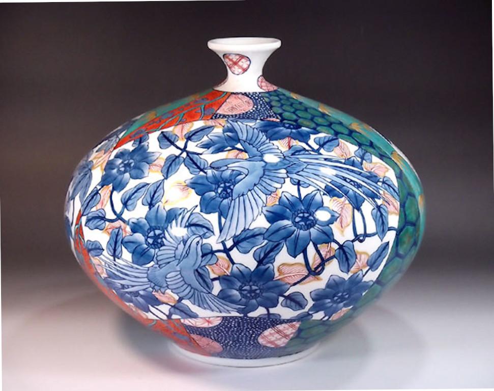 Exquisite contemporary Japanese decorative porcelain vase, elegantly hand painted in iron-red, green and blue on the finest porcelain in a stunning shape, a signed masterpiece by widely acclaimed award-winning master porcelain artist in the