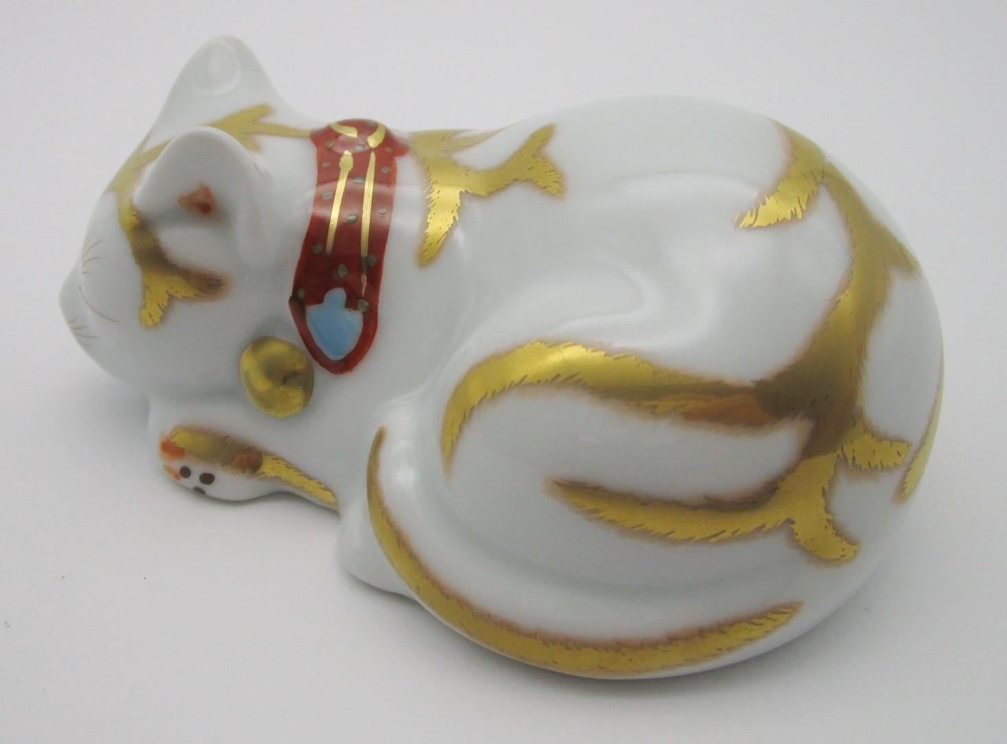 Charming contemporary Japanese Imari sleeping cat in fine pure white porcelain with generous gold details, is inspired by the small wooden sculpture at the entrance of Toshougu shrine in Nikko, Japan, by the acclaimed sculpture artist and architect