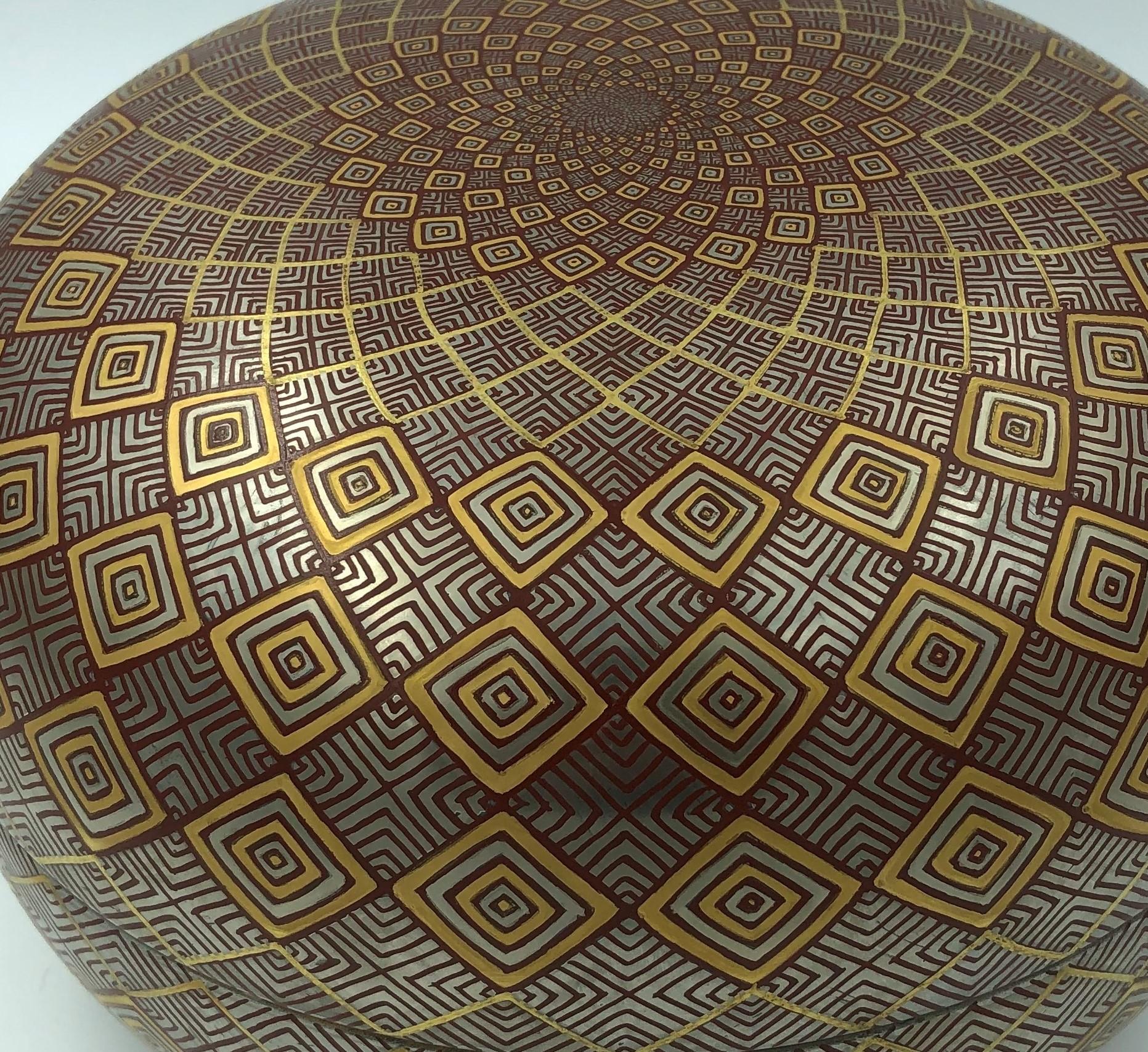 Mesmerizing Japanese contemporary decorative porcelain box, extremely intricately platinum and gold gilded and hand painted on an exquisite ovoid shape body, featuring an extremely intricate geometric progression expressed in red, gold and platinum.