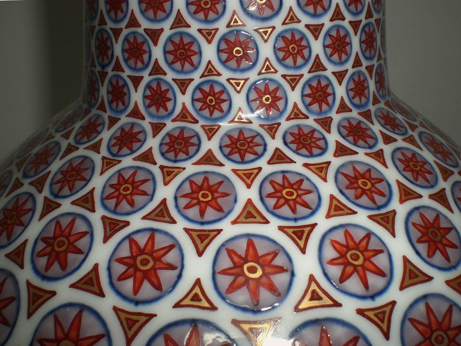 Extraordinary Japanese contemporary large decorative porcelain vase, intricately hand painted and gilded on a beautiful bottle shaped body in deep red, white and blue, a signed masterpiece by master porcelain artist of the Imari-Arita region of