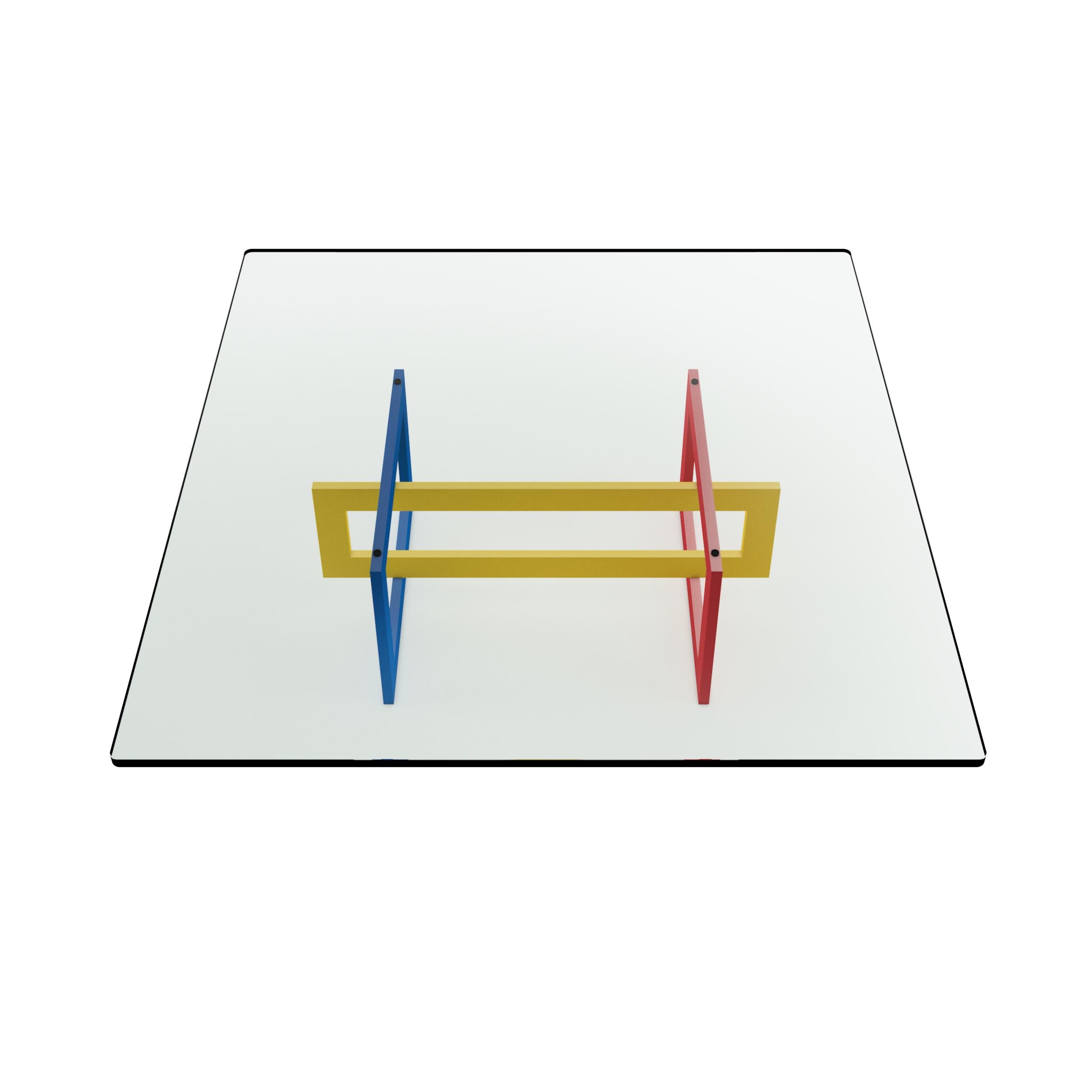 The low Jonathan table features a tubular metal 20 x 60mm frame, epoxy coated in glossy red, blue and yellow colors in the 