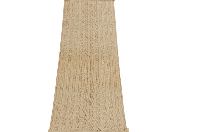 Crafted with natural fiber, a 2x6 runner from Rug & Kilim’s modern selections. The beautiful neutral piece enjoys braid technique in a comforting beige yarn made with jute & sisal fibers. Relishing an exemplary tactility, a runner well suited for an