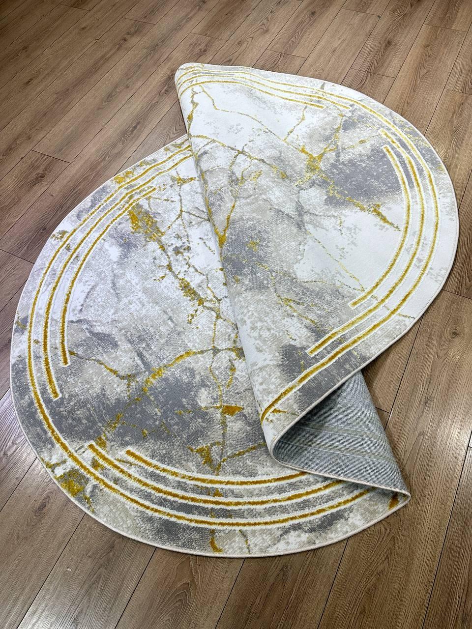 This contemporary Kazakh rug features a modern design with abstract patterns in an elegant oval shape. Machine-made from a blend of cotton and polyester, this lightweight rug showcases a vibrant color scheme of yellow, white, and