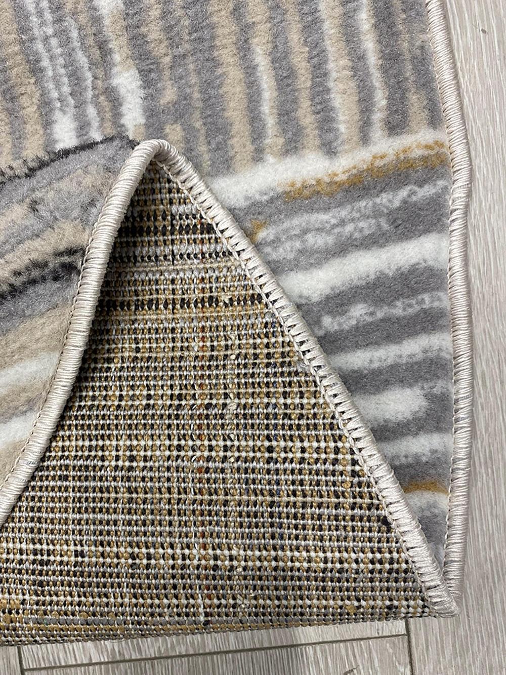 This contemporary Kazakh rug features a modern design with abstract and geometric patterns, presented in an elegant oval shape. Machine-made from high-quality polypropylene, this lightweight rug comes in a sophisticated color palette of beige and