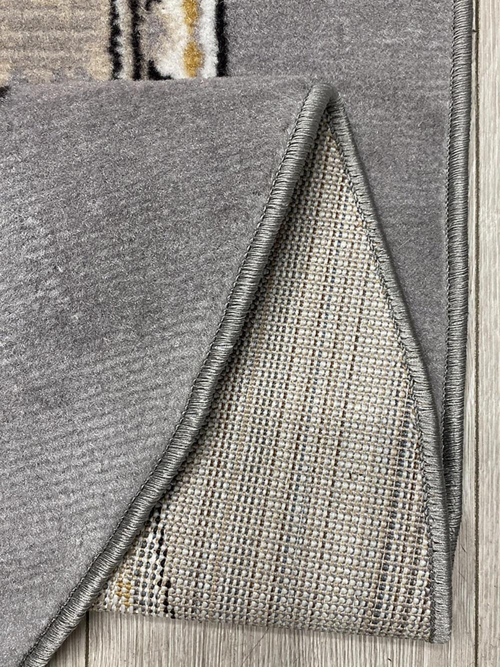 This stylish contemporary Kazakh rug features a modern design with a blend of botanical and geometric patterns, perfect for adding a touch of elegance to any room. Machine-made from high-quality polypropylene, this lightweight rug comes in a