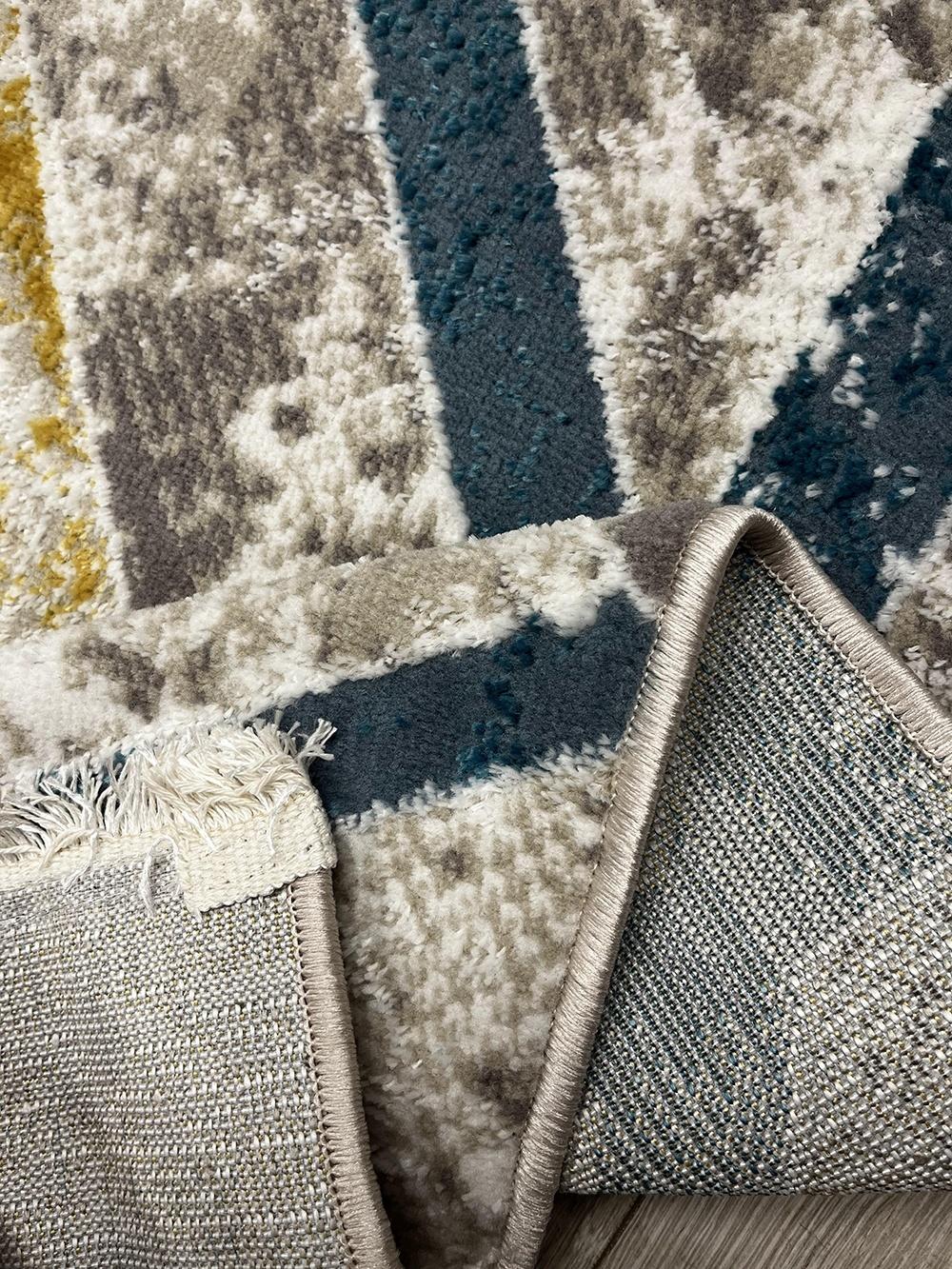 This contemporary Kazakh rug features a modern design with an abstract geometric pattern, perfect for adding a touch of sophistication to any room. Machine-made from a blend of polypropylene and polyester, this lightweight rug comes in a stylish