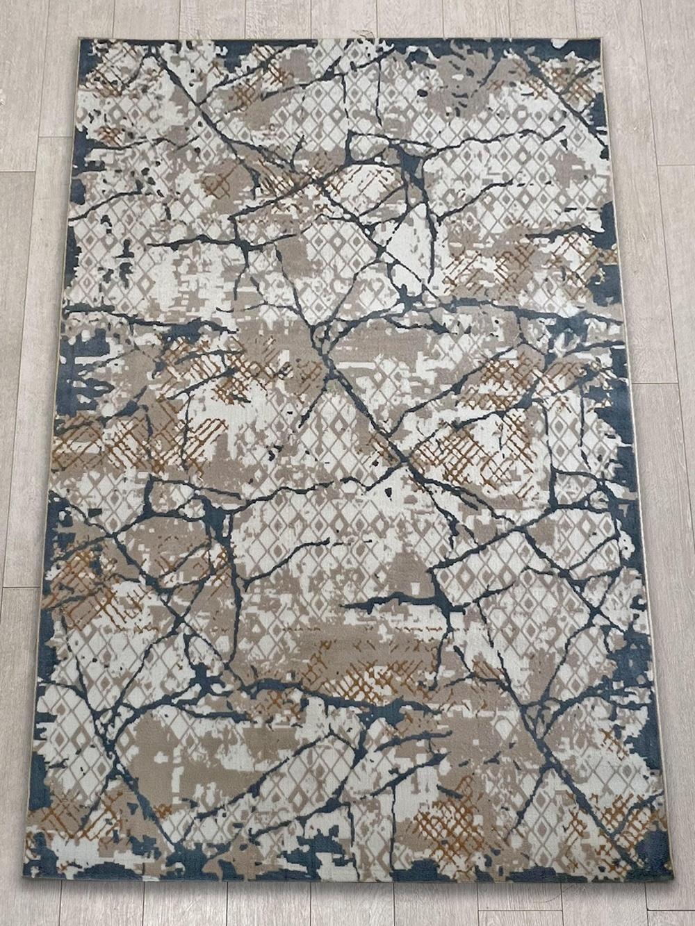 This contemporary Kazakh rug features a modern design with abstract patterns, adding a touch of elegance to any room. Machine-made from high-quality polypropylene, this lightweight rug comes in a stylish color palette of blue, white, and