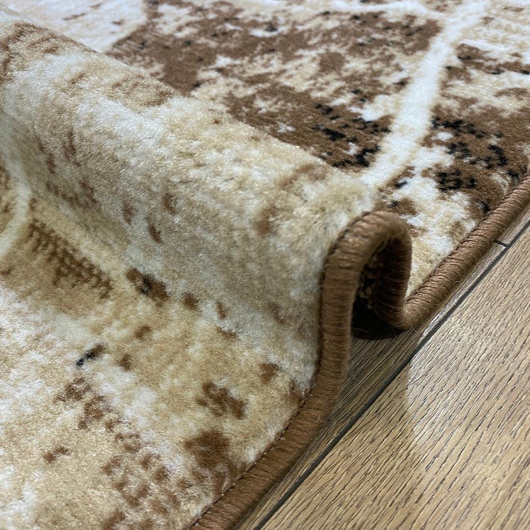 This contemporary Kazakh rug features a modern design with abstract patterns, presented in an elegant oval shape. Machine-made from a blend of polypropylene and jute, this lightweight rug comes in a sophisticated color palette of beige and