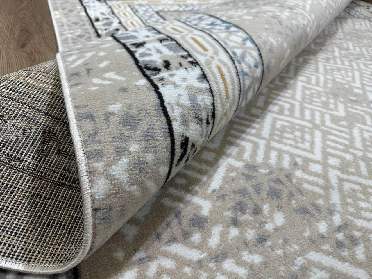 This contemporary Kazakh rug features a modern design with abstract and contemporary patterns, ideal for adding a sophisticated touch to any room. Machine-made from a high-quality blend of polypropylene and jute, this lightweight rug comes in a