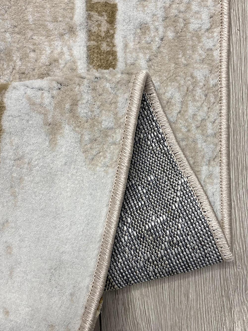 This contemporary Kazakh rug features a modern design with abstract and geometric patterns, adding a touch of sophistication to any room. Machine-made from high-quality polypropylene, this lightweight rug comes in a stylish beige and gray color