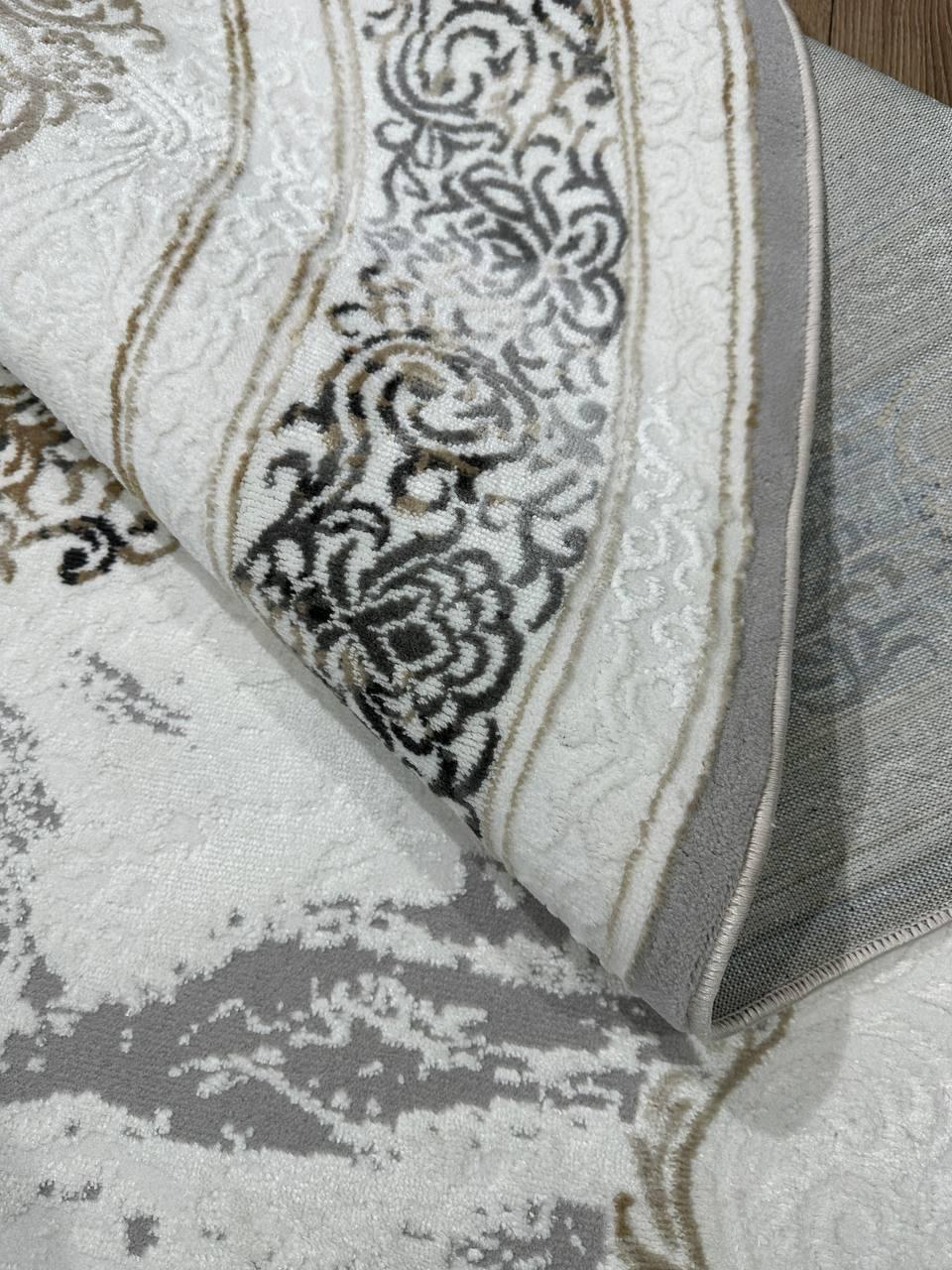 Contemporary Kazakh Oval Rug

Type: Rug
Shape: Oval
Material: Cotton and Polyester
Pattern: Classic, Neoclassical
Dimensions: 150 x 230 cm (approximately 4.9 x 7.5 ft)
Country of Manufacture: Kazakhstan
Color: White and Gray
Weight: Lightweight
This