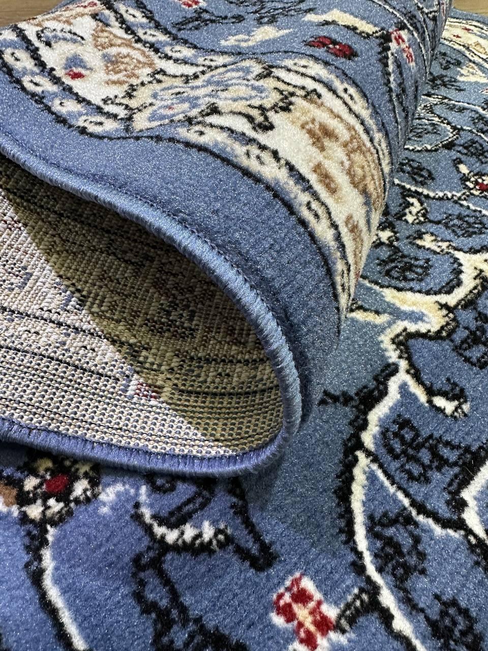 This contemporary Kazakh rug features a classic Tabriz design in a stylish oval shape. Machine-made from a blend of polypropylene and jute, this lightweight rug showcases a rich blue color that adds elegance to any room.

Features:

Type: Rug
Shape:
