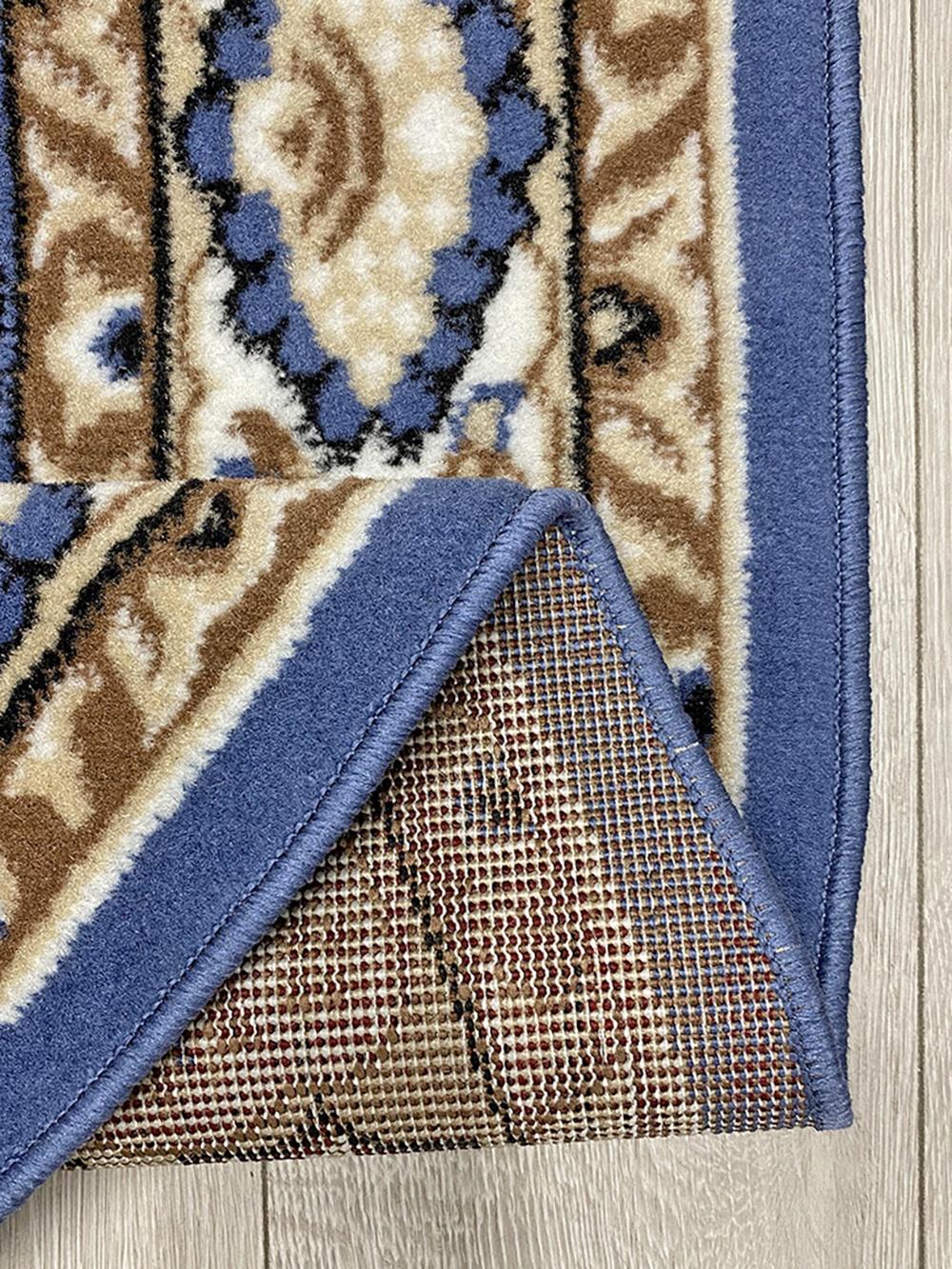 This elegant contemporary Kazakh oval rug features a classic Tabriz style design, adding a sophisticated touch to any room. Machine-made from high-quality polypropylene, this lightweight rug comes in a vibrant blue color, enhancing its timeless