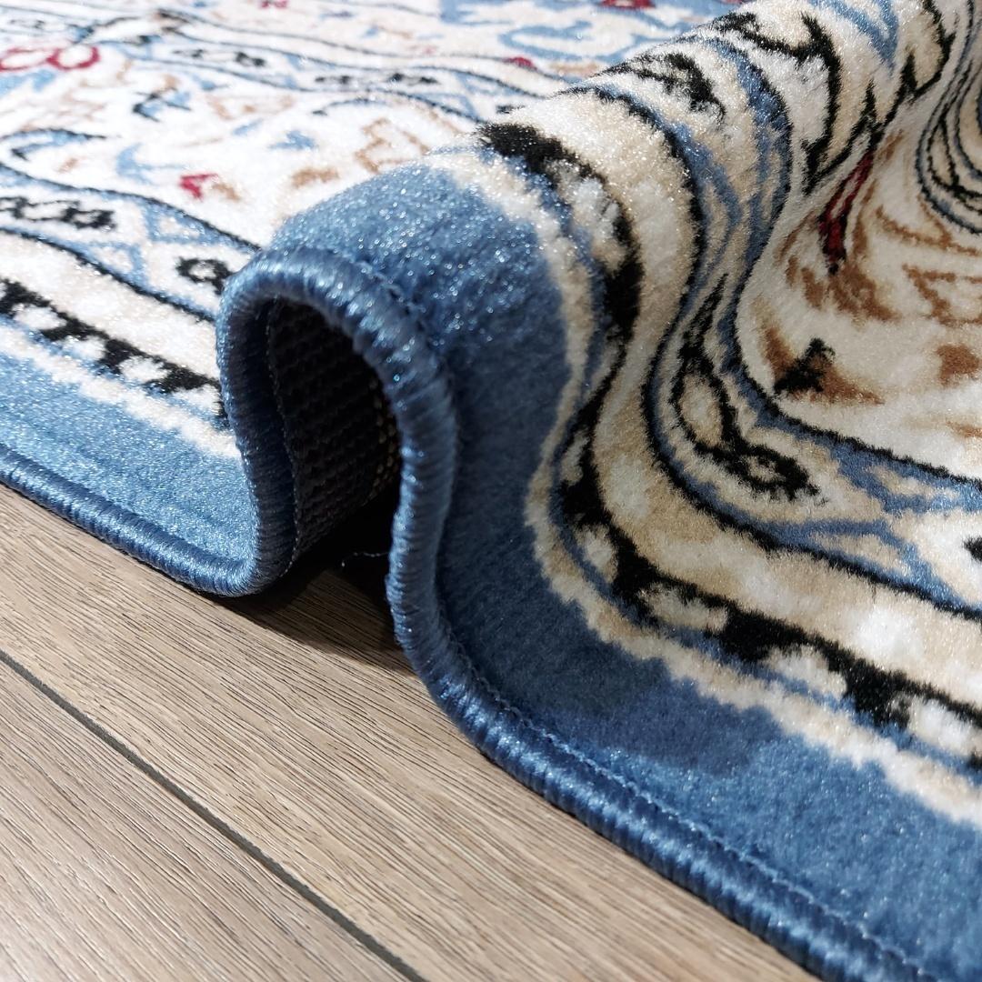 This beautiful contemporary rug from Kazakhstan features a classic Tabriz style pattern and is machine-made from a blend of high-quality polypropylene and jute. The rich blue color adds a touch of elegance to any room, making it a stylish and