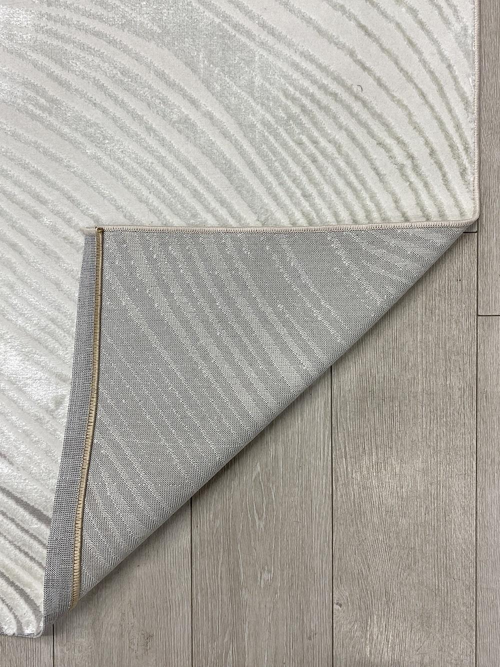 This contemporary Kazakh rug features a modern design with abstract and geometric patterns, perfect for adding a stylish touch to any room. Machine-made from high-quality polyester, this lightweight rug comes in a sophisticated white and gray color