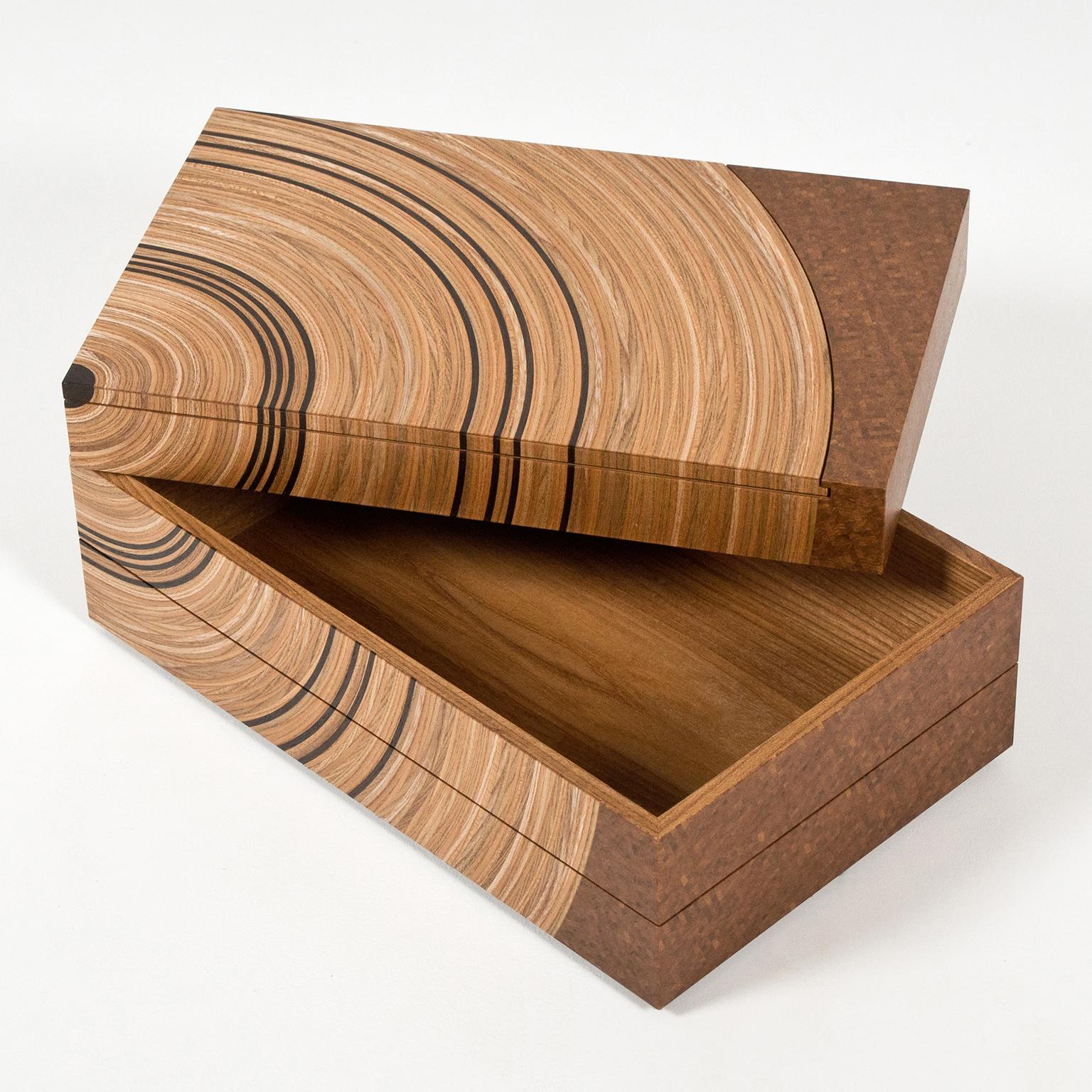The contemporary 'Family Tree' keepsake box by Edward Johnson is made in elm and walnut. The concept behind the Family Tree keepsake box is to subtly represent the generations of your family. This piece is a contemporary twist on a traditional