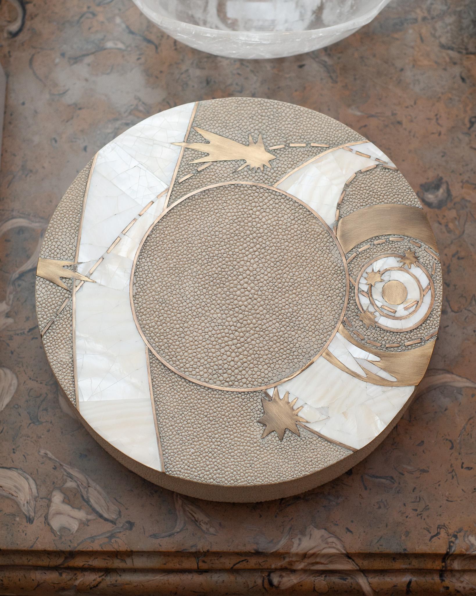 In stock now - A gorgeous Kifu Paris decorative box in creme shagreen over a base of walnut, with brass, creme shagreen and white shell inlay lid. Expertly crafted in a celestial motif, this decorative box is a perfect accessory for any table and is