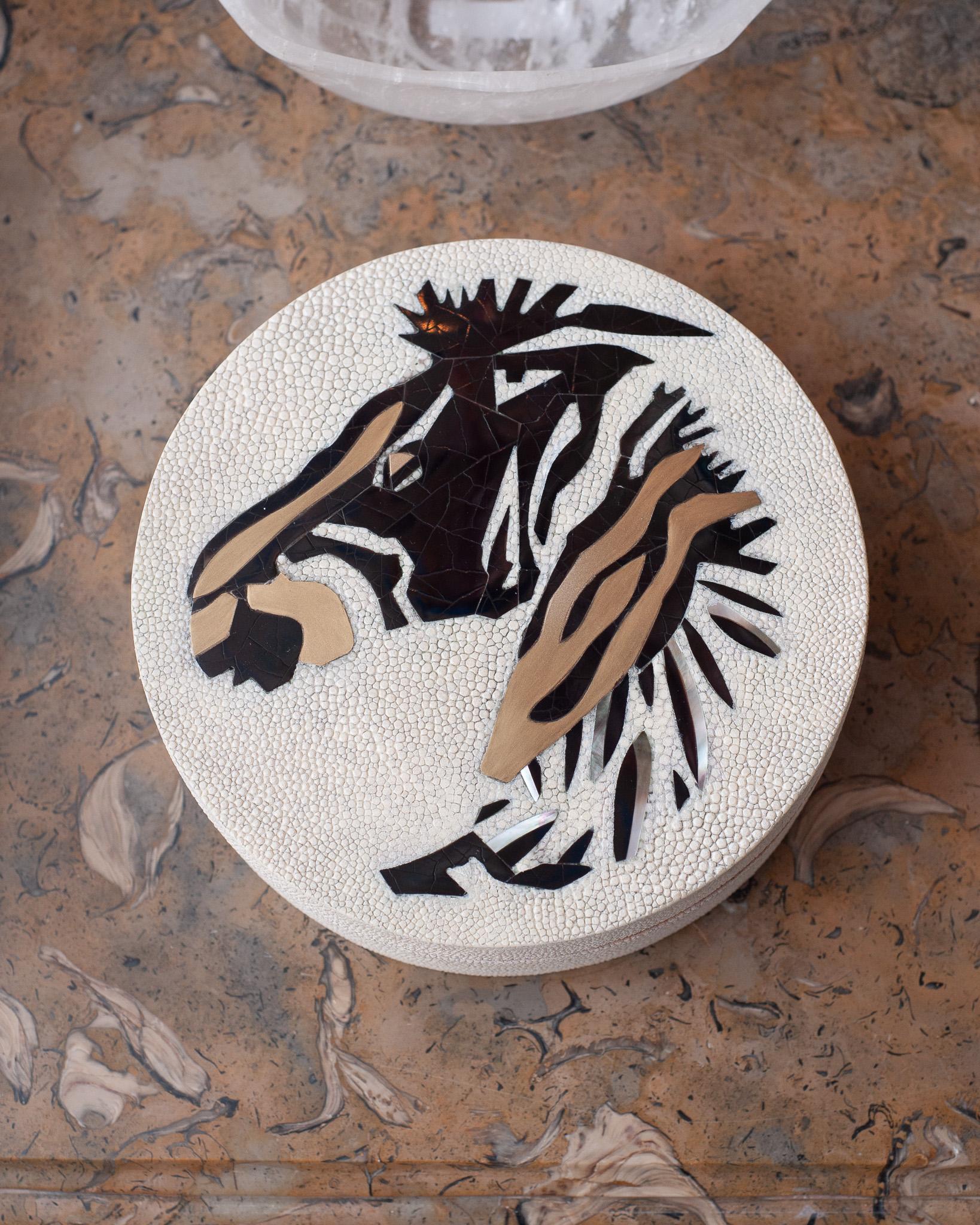 In stock now - A gorgeous Kifu Paris decorative box in creme shagreen over a base of walnut, with brass, creme shagreen, black penshell, and white mother of pearl inlay lid. Expertly crafted in a Zebra motif, this decorative box is a perfect