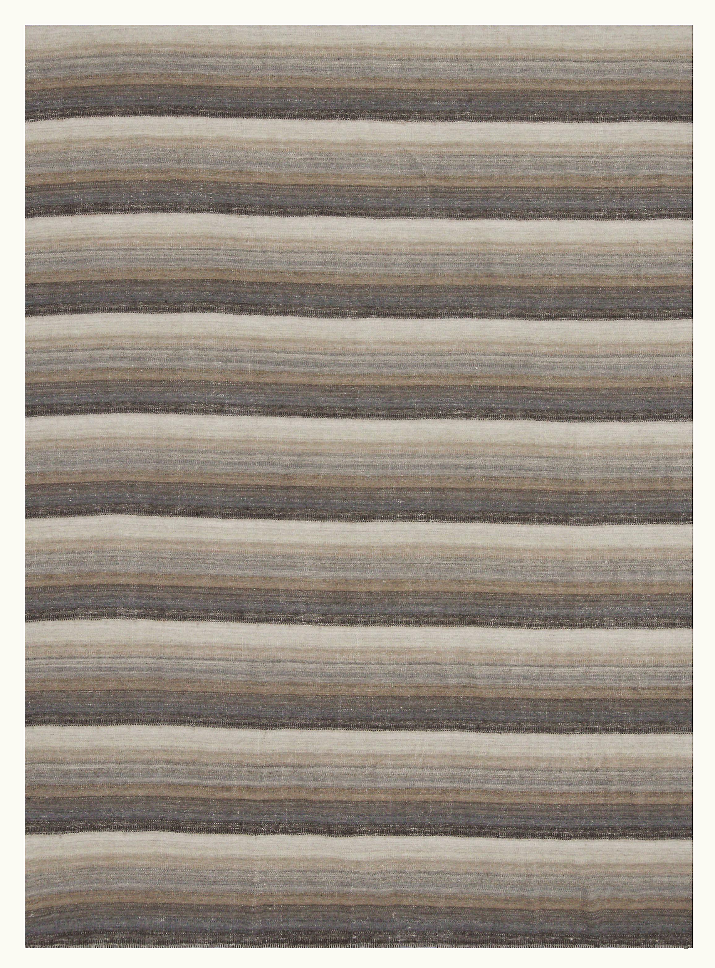 A new production Turkish rug handwoven from the finest sheep’s wool and colored with all-natural vegetable dyes that are safe for humans and pets. It’s a traditional Kilim flat-weave design featuring a beautiful ivory field with a mix of beige,