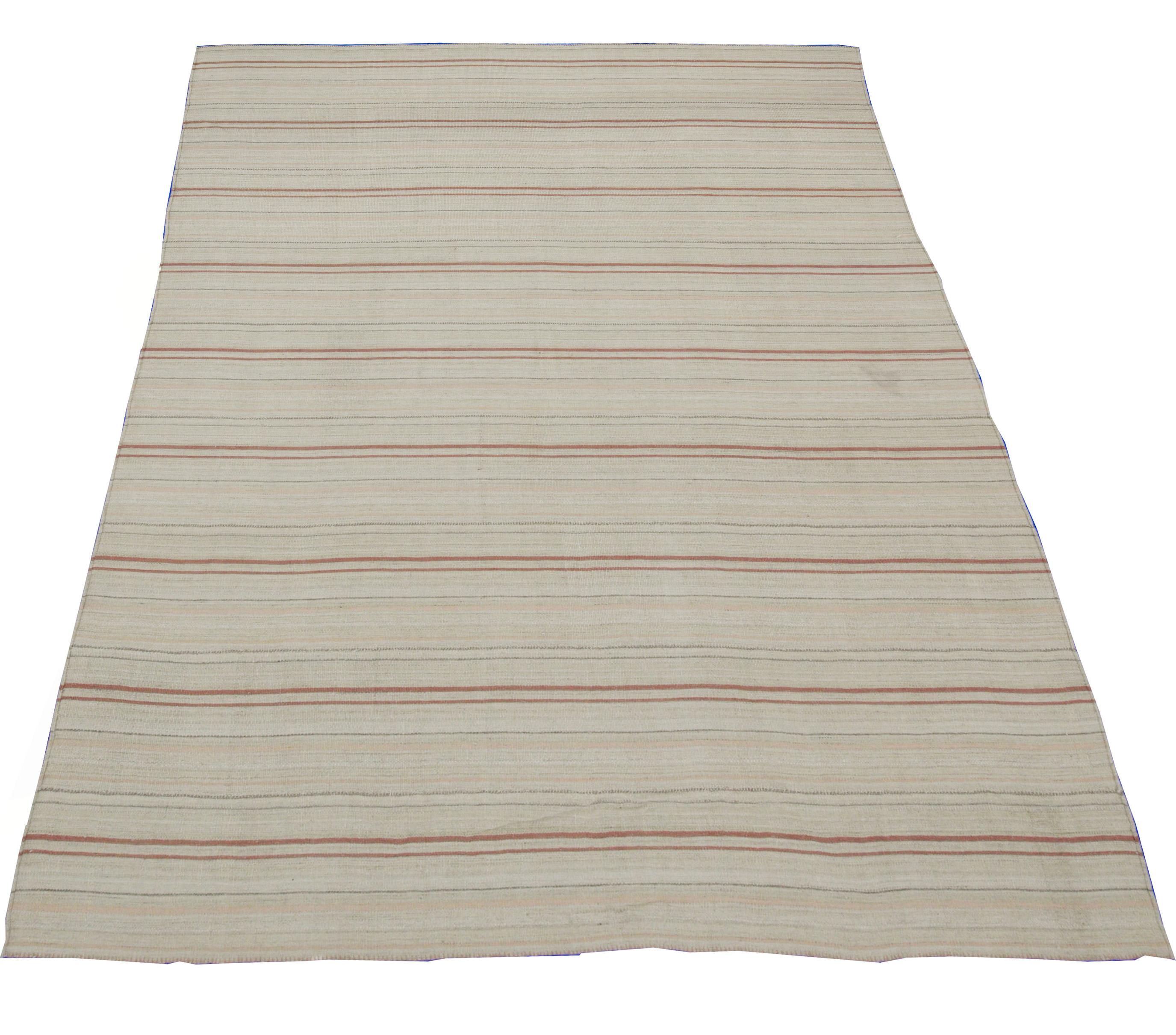 A new production Turkish rug handwoven from the finest sheep’s wool and colored with all-natural vegetable dyes that are safe for humans and pets. It’s a traditional Kilim flat-weave design featuring a beautiful ivory field with a mix of beige,
