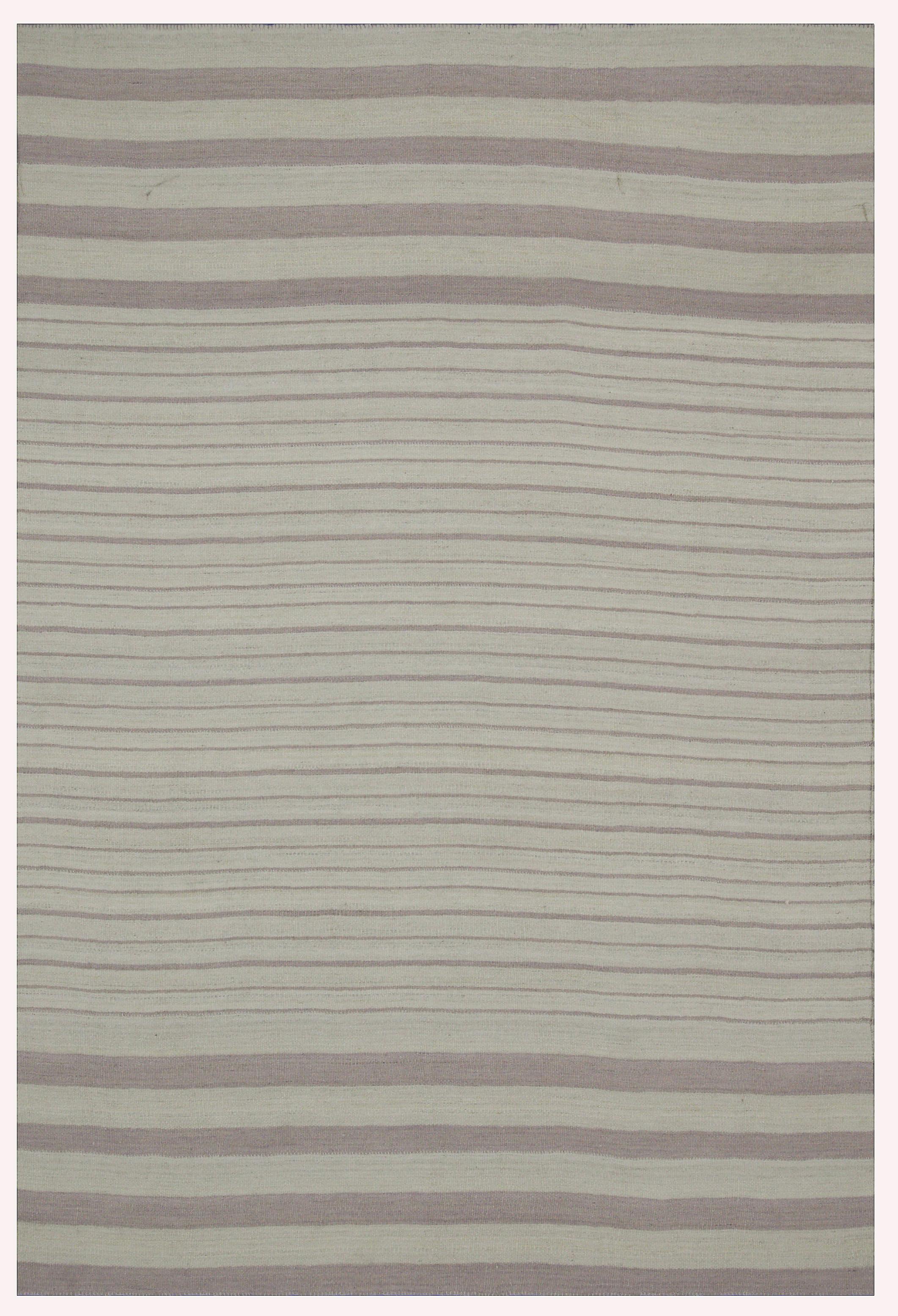 A new production Turkish rug handwoven from the finest sheep’s wool and colored with all-natural vegetable dyes that are safe for humans and pets. It’s a traditional Kilim flat-weave design featuring a beautiful ivory field with gray stripes. It’s a