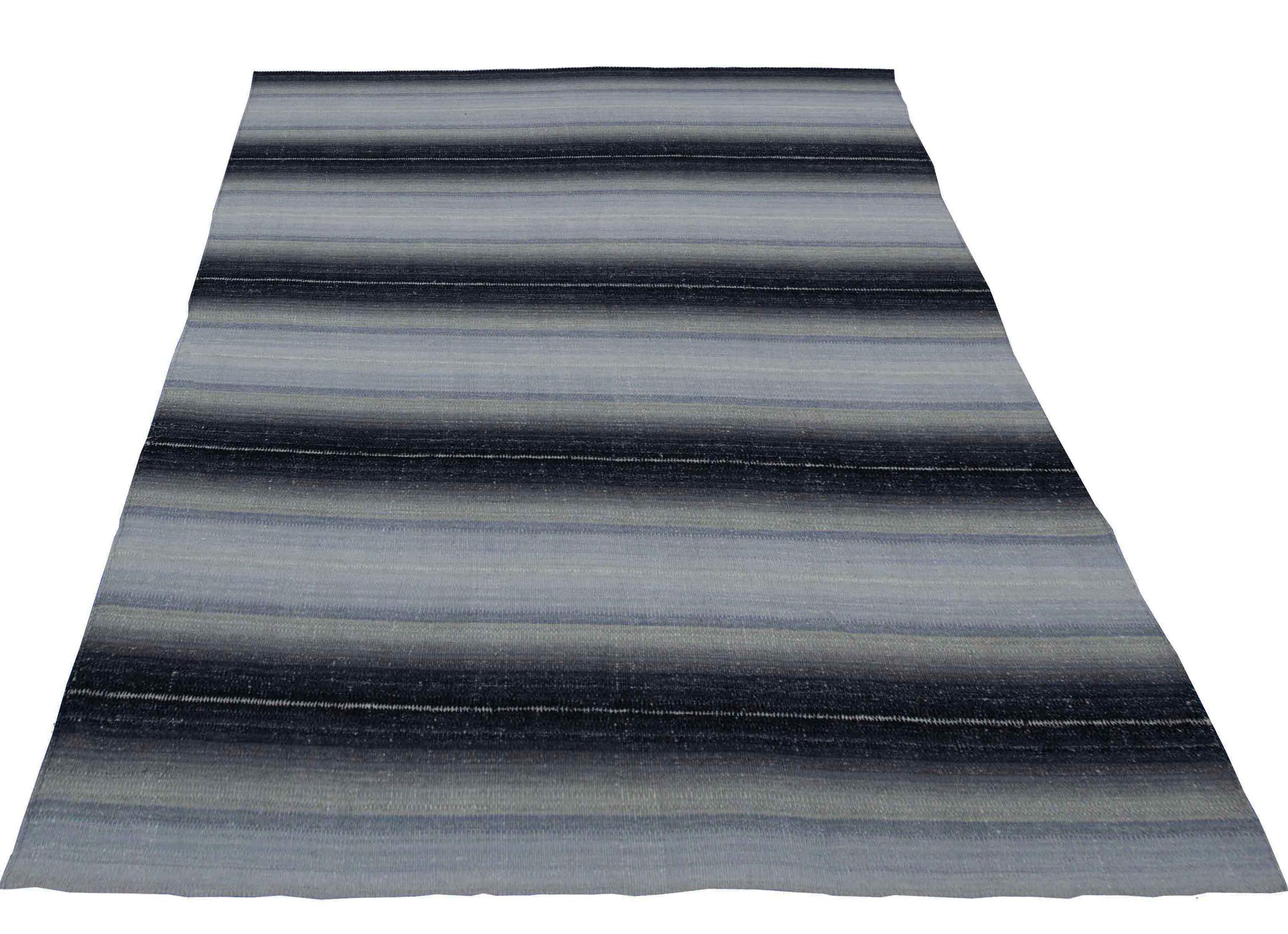 A new production Turkish rug handwoven from the finest sheep’s wool and colored with all-natural vegetable dyes that are safe for humans and pets. It’s a traditional Kilim flat-weave design featuring a lovely beige field with black and gray stripes.